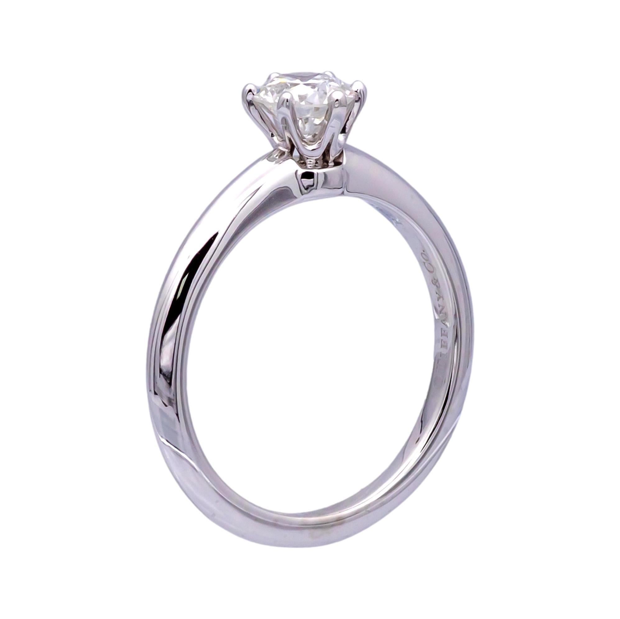 Pre-Owned Tiffany & Co. solitaire engagement ring finely crafted in a 6 prong platinum mounting featuring a round brilliant cut center weighing 0.70 carats, G color SI1 clarity diamond with excellent cut , polish and symmetry. Original certificate