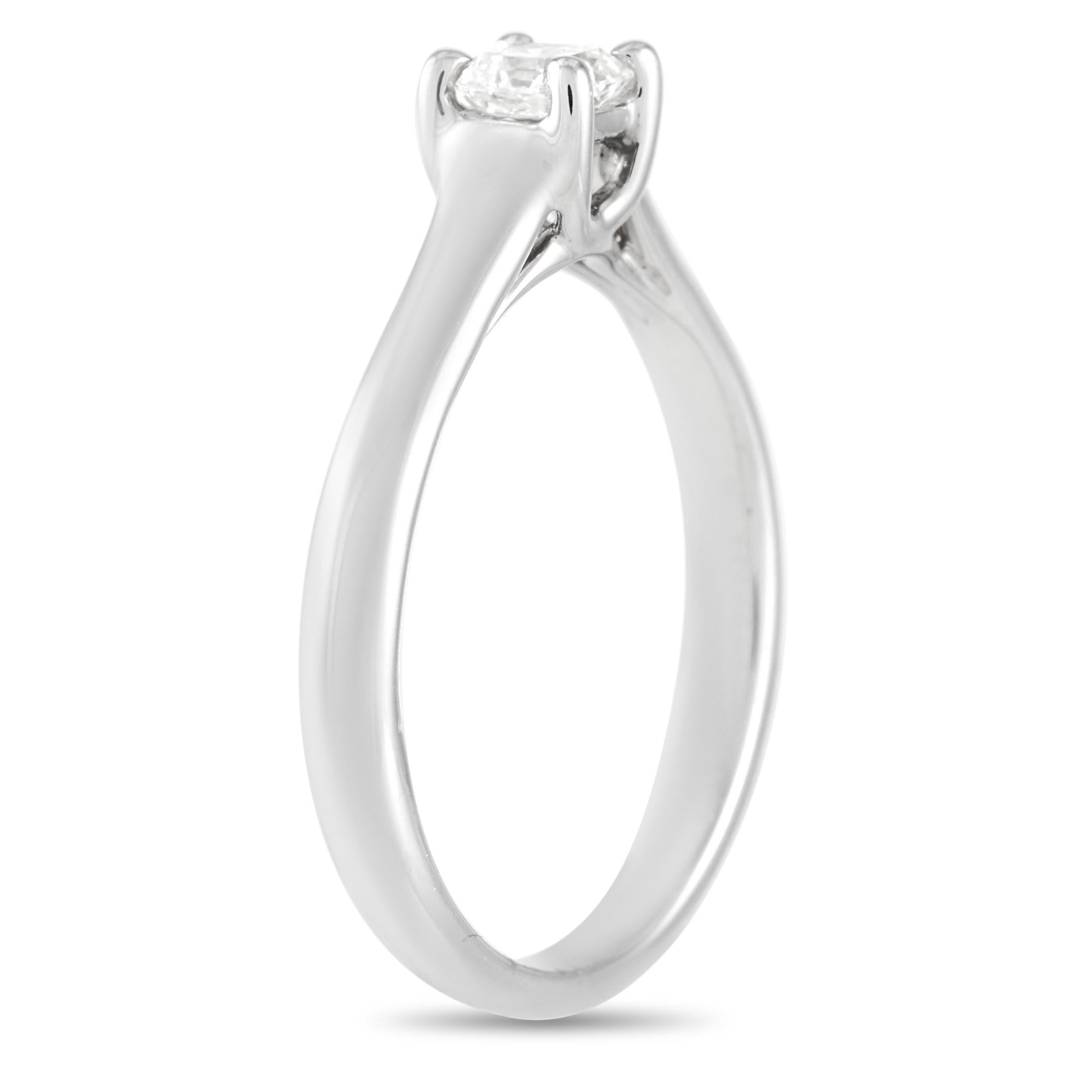 This classic Tiffany & Co. Platinum Solitaire Lucida Diamond Engagement Ring is a timeless piece. The simple band is made with platinum and highlights a solitary Lucida diamond of H color and VVS2 clarity. The ring weighs a total of 3.6 grams and