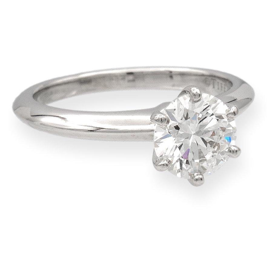 Tiffany & Co. solitaire engagement ring finely crafted in platinum featuring a fine 1.00 carat , H color and VS1 clarity round brilliant cut diamond set in six prongs. This ring has excellent cut, polish and symmetry, considered triple X.  Ring is