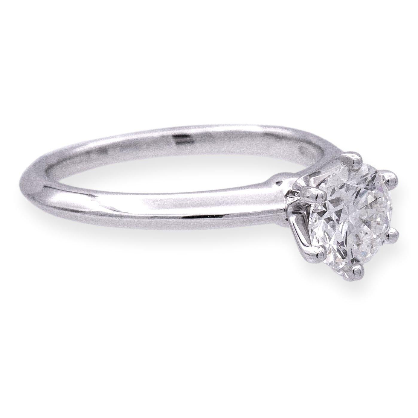 Tiffany & Co. Solitaire diamond engagement ring finely crafted in a six prong platinum mounting featuring a 1.03 carat round brilliant diamond center graded H color and VS1 Clarity. The diamond is inscribed with Tiffanys serial numbers and is