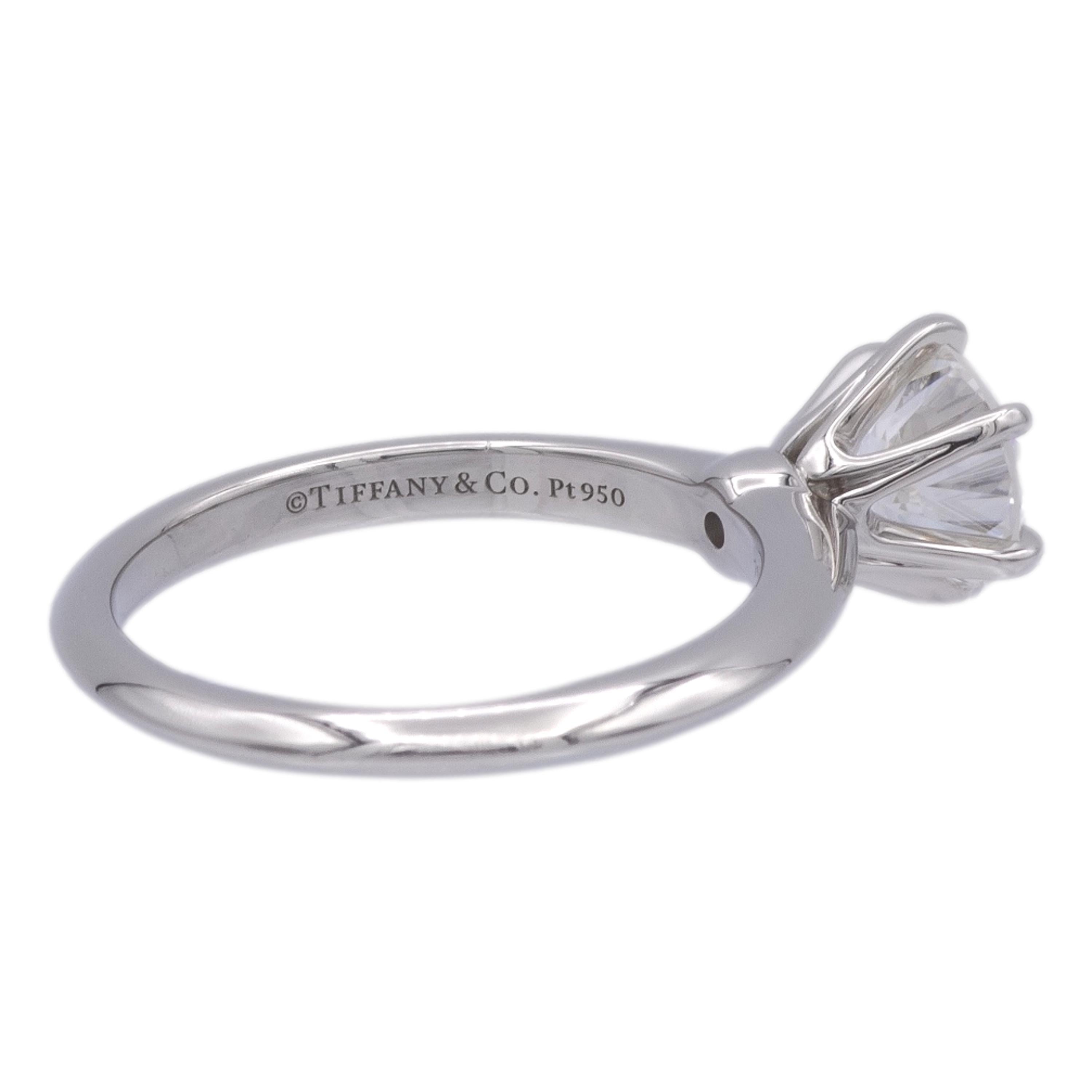 Tiffany & Co. Solitaire Diamond Engagement ring finely crafted in a six prong platinum mounting featuring a 1.31 ct round brilliant diamond center graded G color and VVS2 Clarity. The diamond is inscribed with Tiffanys serial numbers and