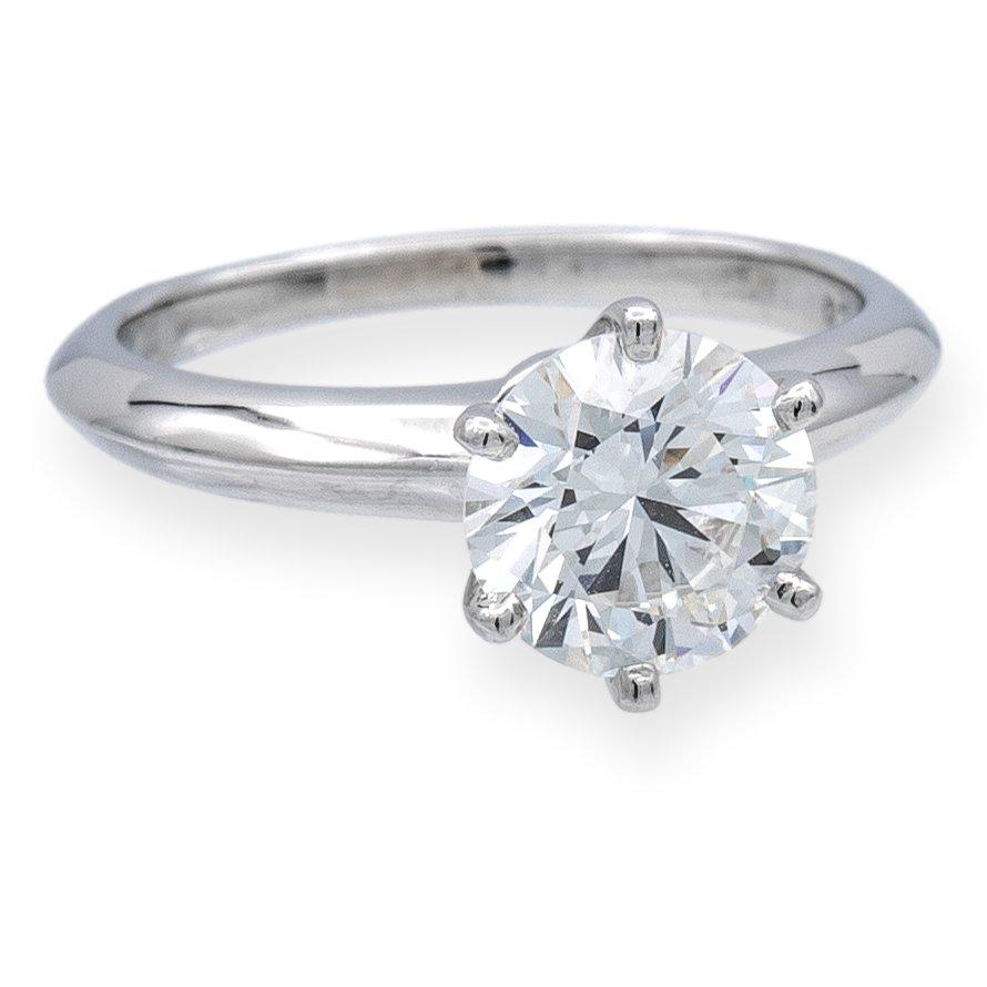 Tiffany & Co. Diamond Engagement ring finely crafted in a six prong platinum mounting featuring a 1.33 ct round brilliant diamond center graded H color and VVS2 Clarity. The diamond is inscribed with Tiffanys serial numbers and is graded  Excellent