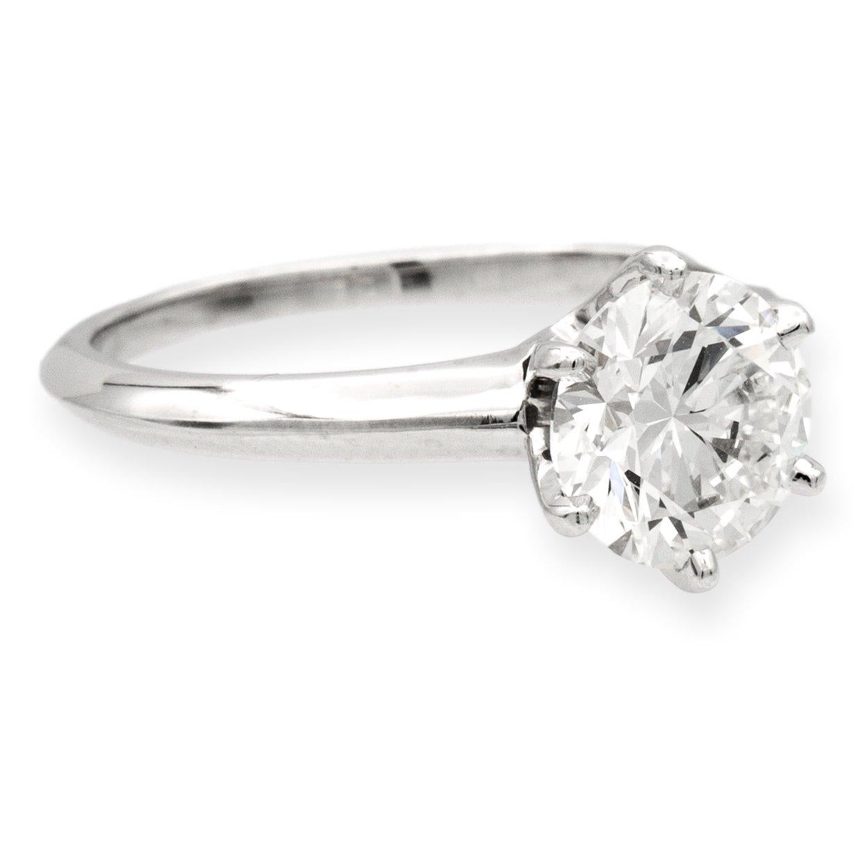 Tiffany & Co. Solitaire diamond engagement ring finely crafted in a six prong platinum mounting featuring a 1.70 carat round brilliant diamond center graded I color and VS1 clarity. The diamond is inscribed with Tiffanys serial numbers and has