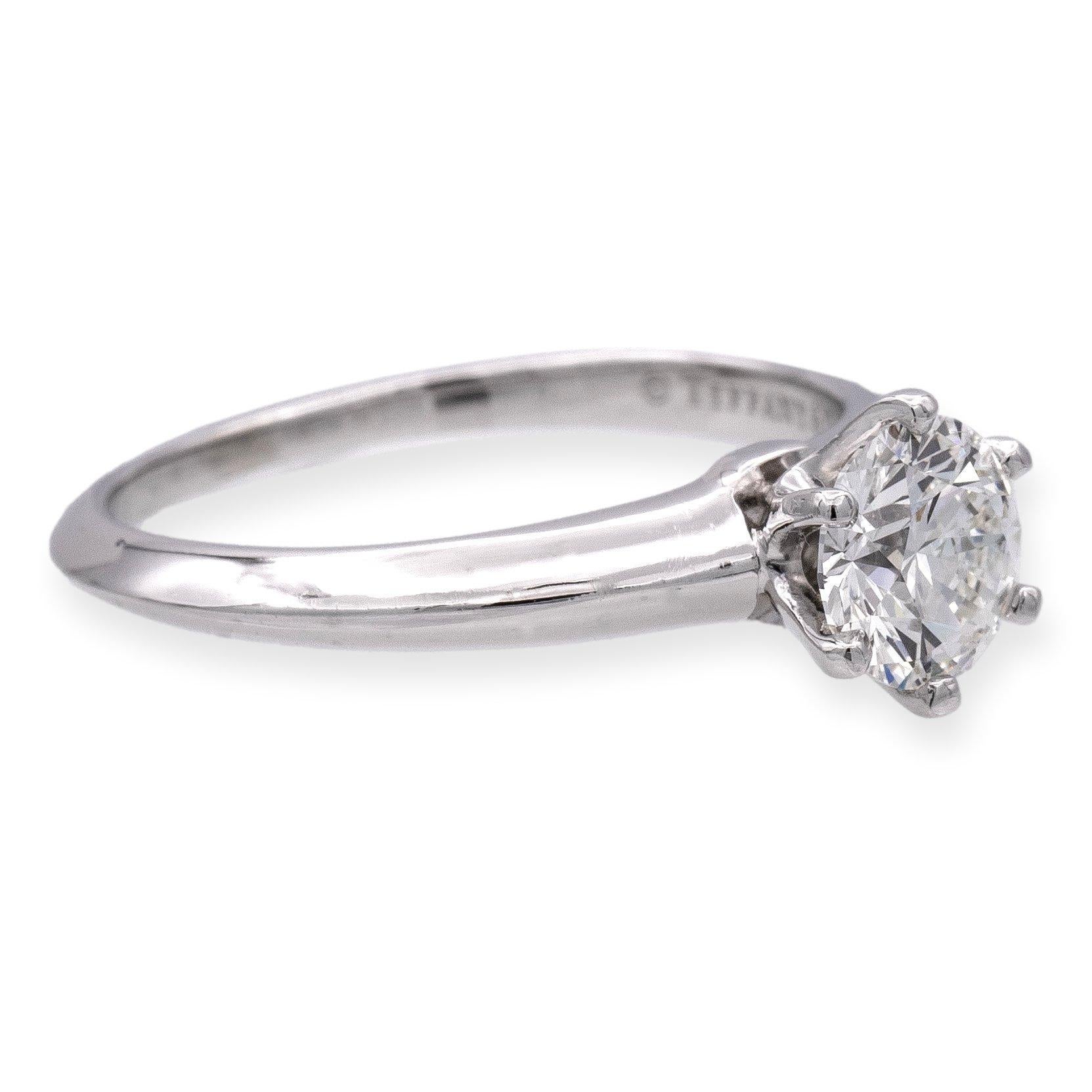 Tiffany & Co. Diamond Engagement Ring featuring a stunning .78ct round cut brilliant diamond, graded F color and VS1 clarity, crafted in a platinum setting. Exuding every detail to perfection, from the flawless stone to the elegant craftsmanship.