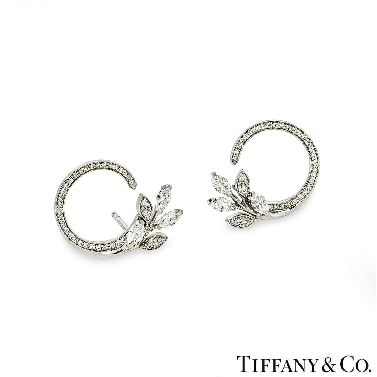 A stunning pair of platinum  earrings by Tiffany & Co. from the Victoria Vine Circle collection. The earrings start with a single row of round brilliant cut diamonds forming an incomplete circle, leading into 3 marquise cut diamonds accompanied by