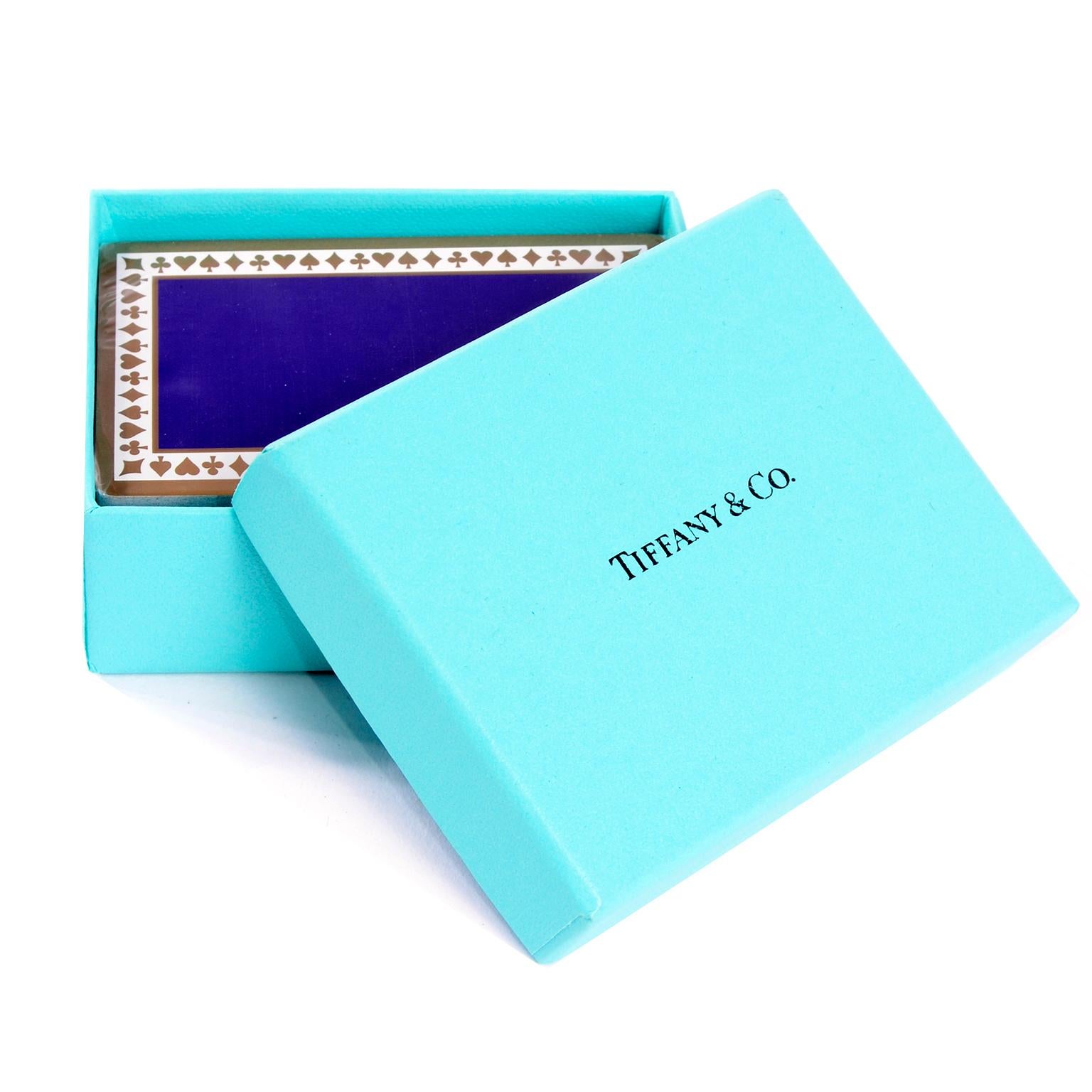 These Tiffany playing cards have never been used. and are still wrapped in their original plastic and in the Tiffany blue box. Cards are purple with gold detail around the edges. These cards would make a perfect gift for the card player in your