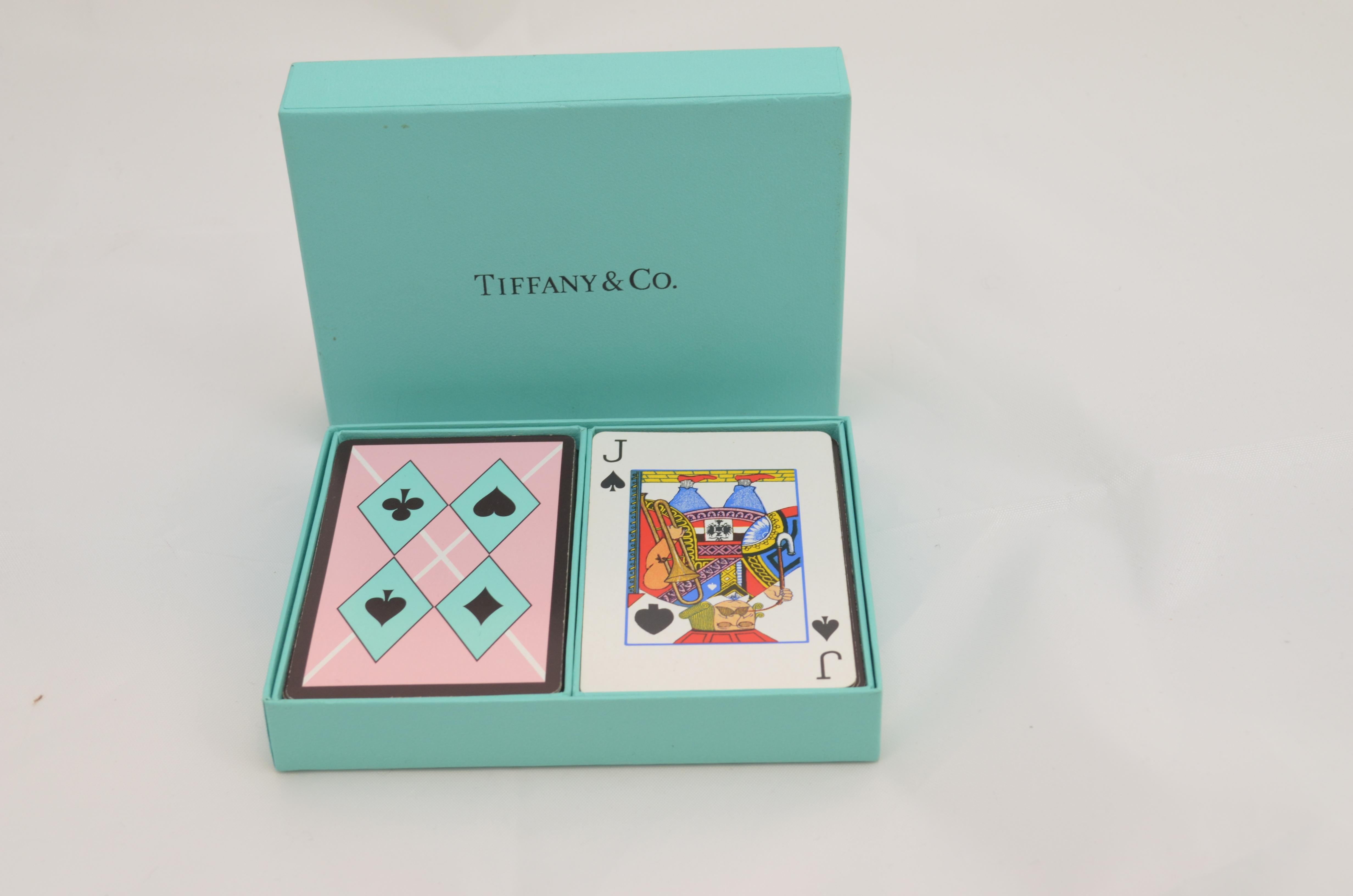 Tiffany & Co. Playing Cards Set -- Two sets of playing cards with a harlequin print in a signature Tiffany's blue box. Measures: 5 x 4 inches.