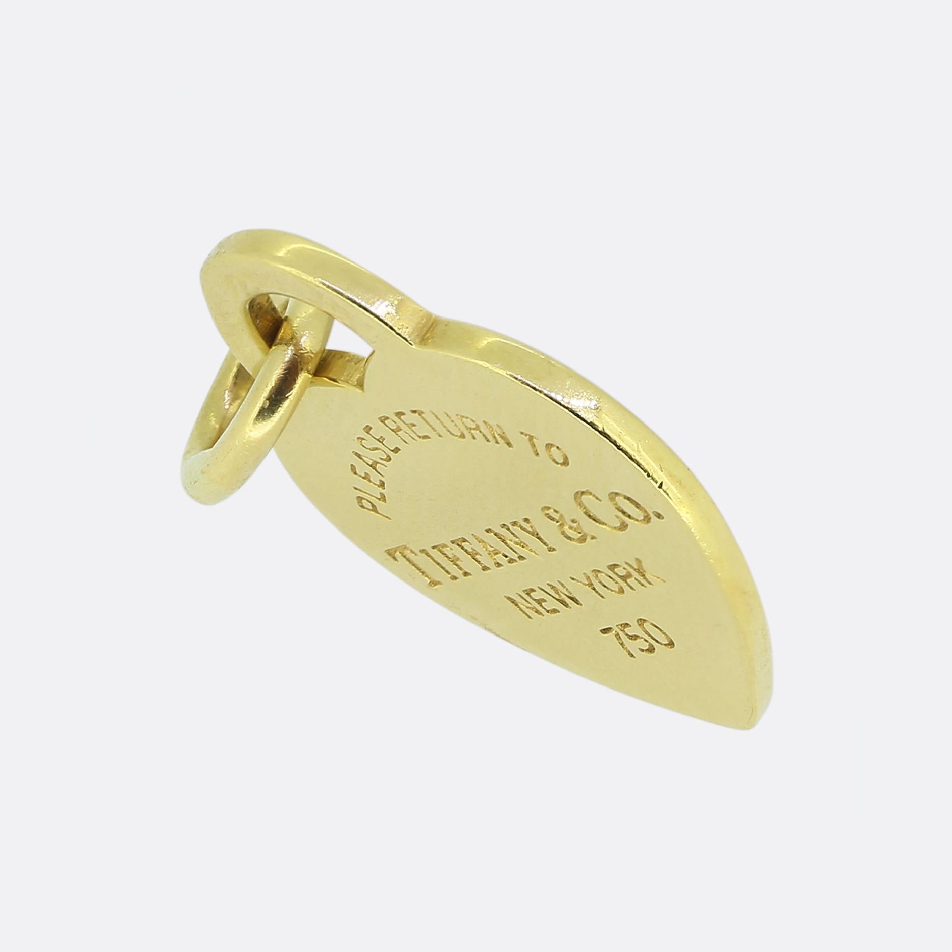 Here we have an iconic charm or pendant from the world renowned jewellery designer, Tiffany & Co. This 18ct yellow gold piece has been crafted into the shape of a heart and features the notorious 'Please Return to Tiffany & Co. New York' engraving