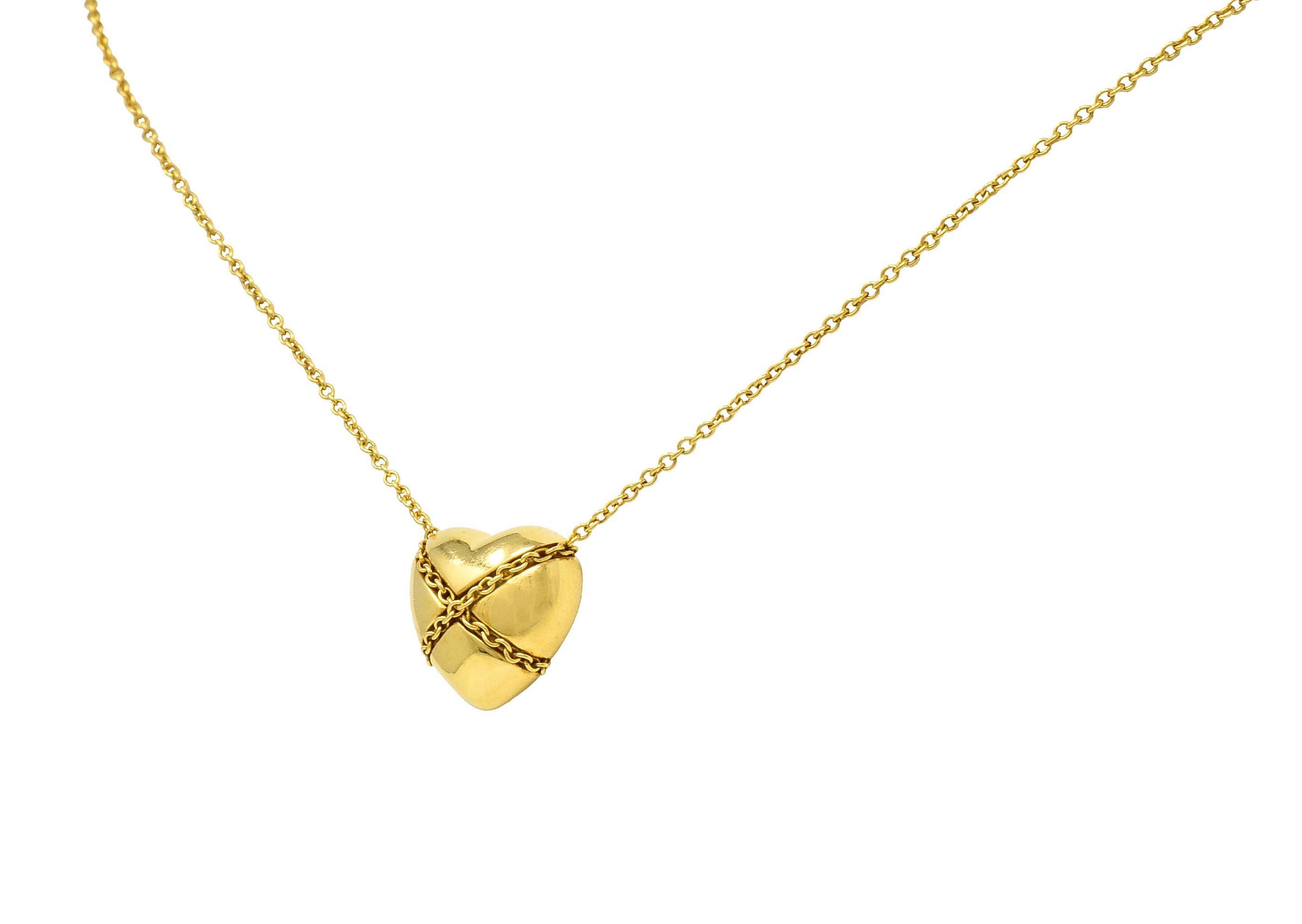 Classic curb chain necklace centers a brightly polished heart

Tightly wrapped with curb chain in an X motif

Necklace completes as a spring ring clasp

Both chain and heart are stamped 750 for 18 karat gold

Heart is stamped T & Co. and chain is