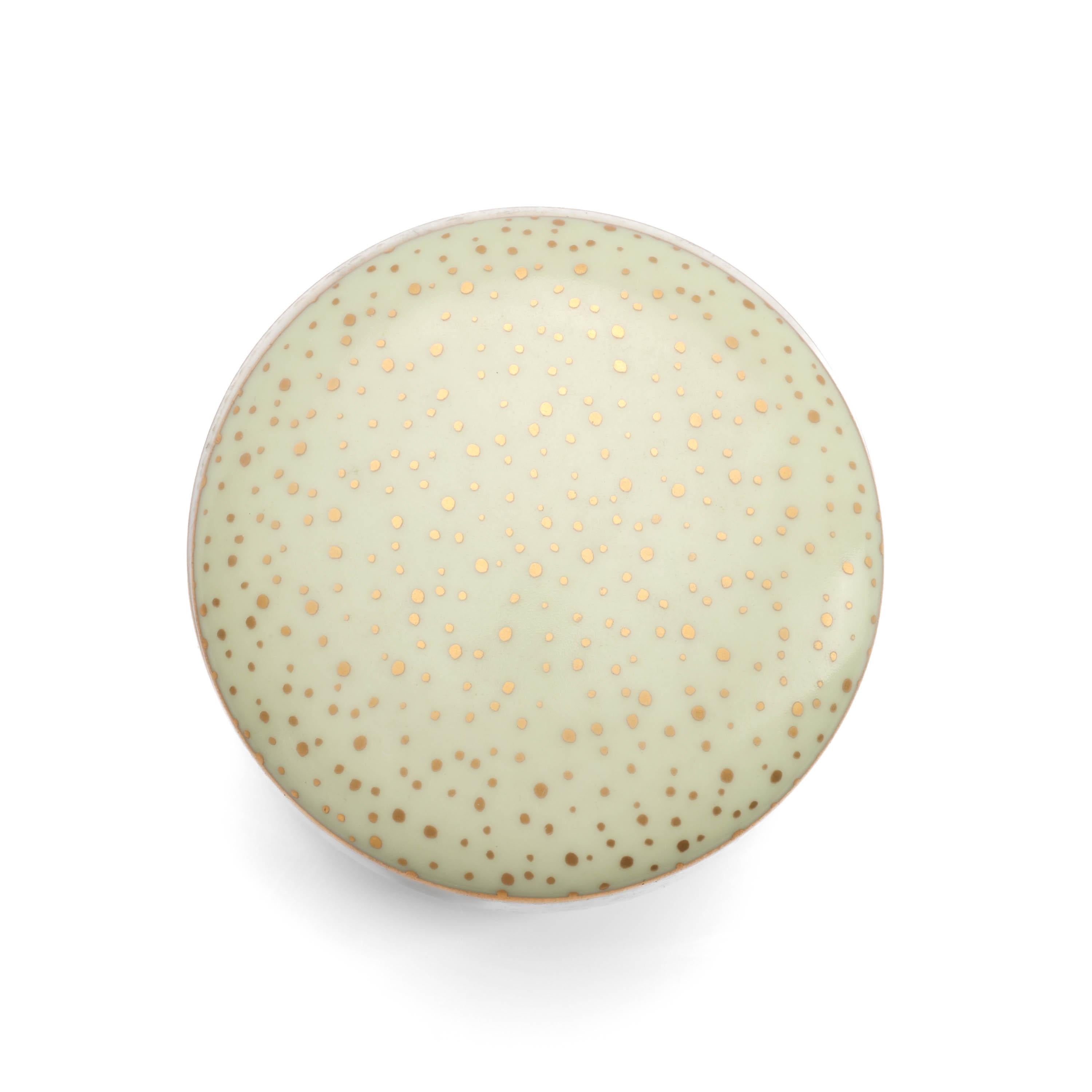 This round Tiffany & Co. porcelain box in celadon green with variable-sized gold dots measures 70mm across 51mm top to bottom, including the lid. Making it the perfect size to hold your rings at night or your diamond stud earrings. Or store your