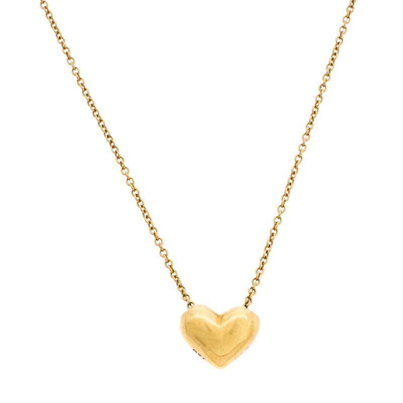 This lovely necklace by Tiffany & Co. will make a timeless addition to your collection. Crafted from 18K yellow gold, this gorgeous creation has a chain that holds a Puffy Heart pendant. It is finished with a spring-ring clasp. The necklace is a