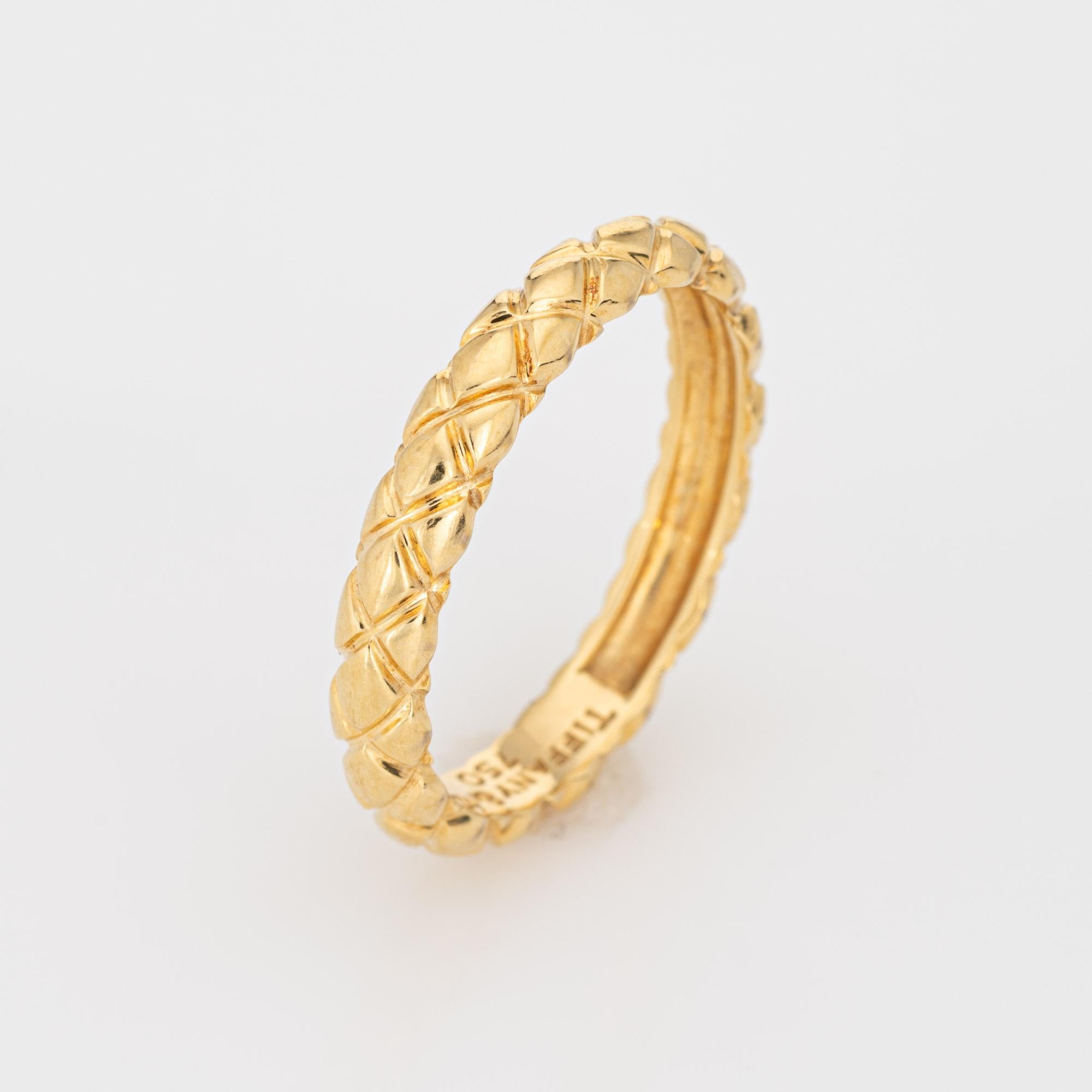 Finely detailed pre-owned Tiffany & Co quilt pattern band crafted in 18k yellow gold. 

The stylish ring features a quilt pattern around the entire band. The ring is great worn alone or stacked with your fine jewelry from any era. The ring is a