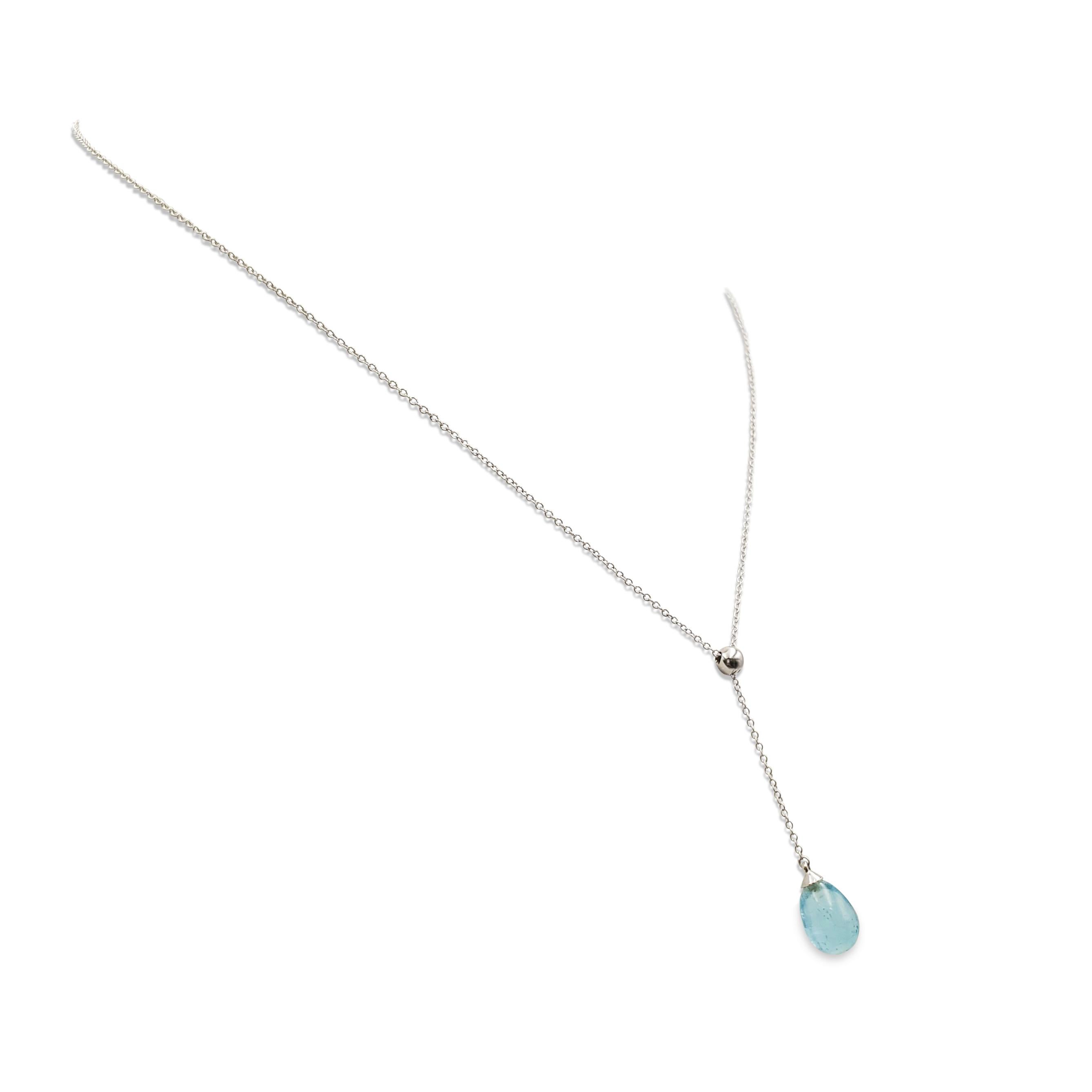 Authentic Tiffany & Co. Rainbow Drop crafted in 18 karat white gold.  Featuring a 1 3/4 inch pendant that is finished with a vibrant aquamarine bead.  The pendant hangs from a delicate 16 inch chain that is signed Tiffany & Co., 750.  Necklace is