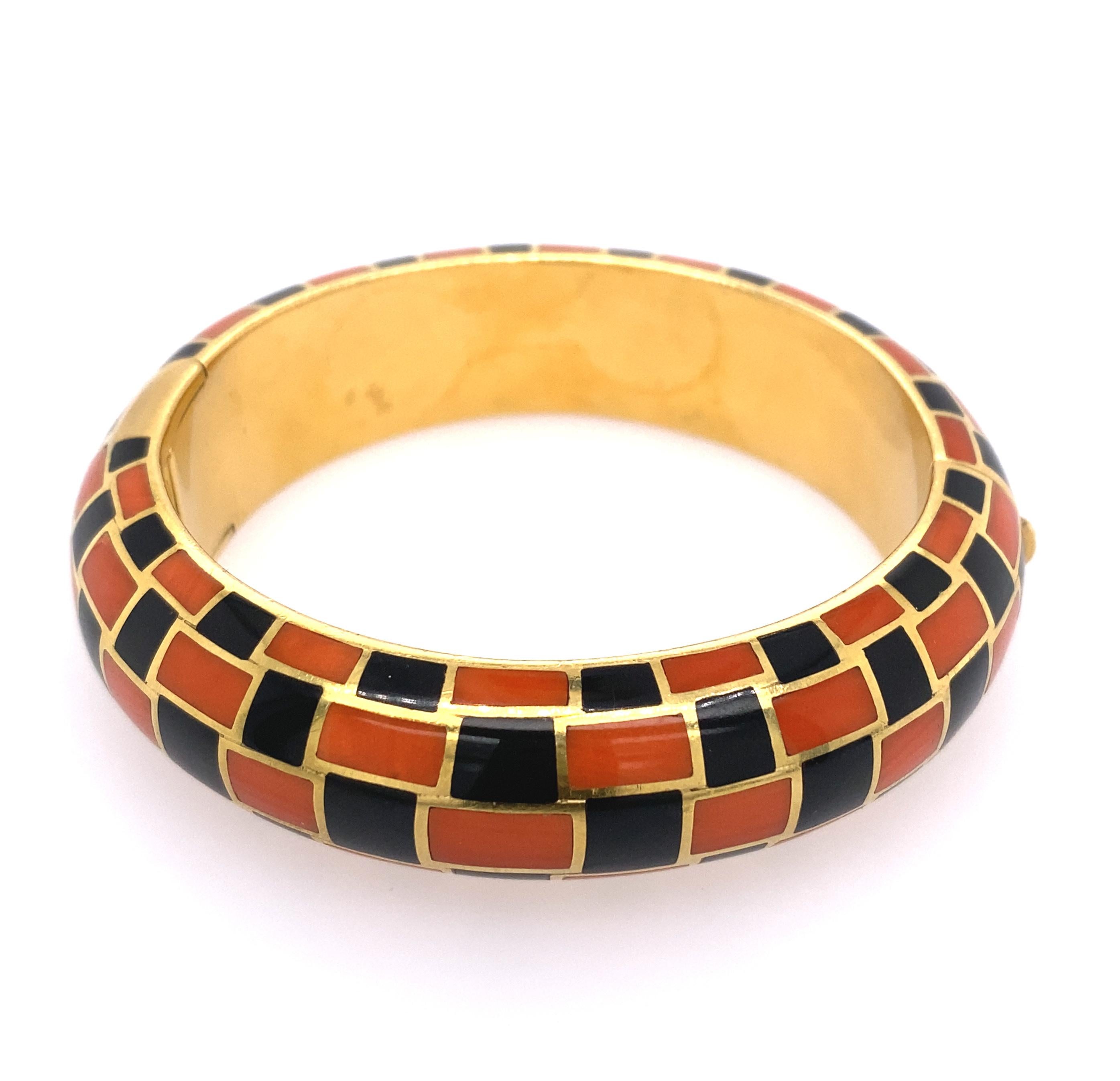 18k gold, coral and black jade bangle, signed Tiffany & Co. 
Total weight 37.0 dwt. Measurement of bracelet wrist 6.50 inches. 
