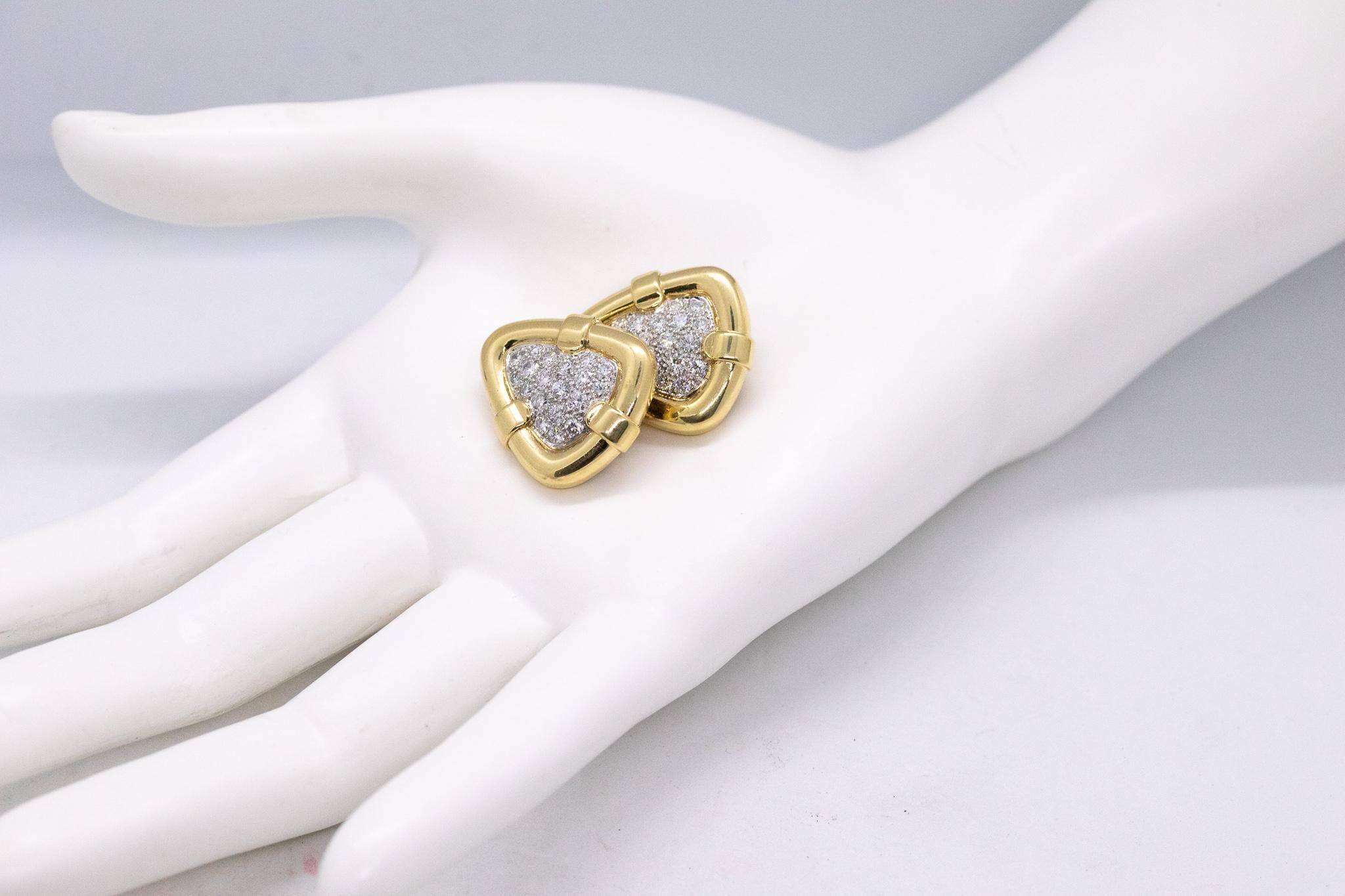 Rare pair of Clips Earrings designed by Tiffany & Co.

Exceptional pair, created in New York city at the Tiffany Studios back in the 1970's. These clips-earrings has been crafted in a trillion triangle shape in solid yellow and white gold of 18