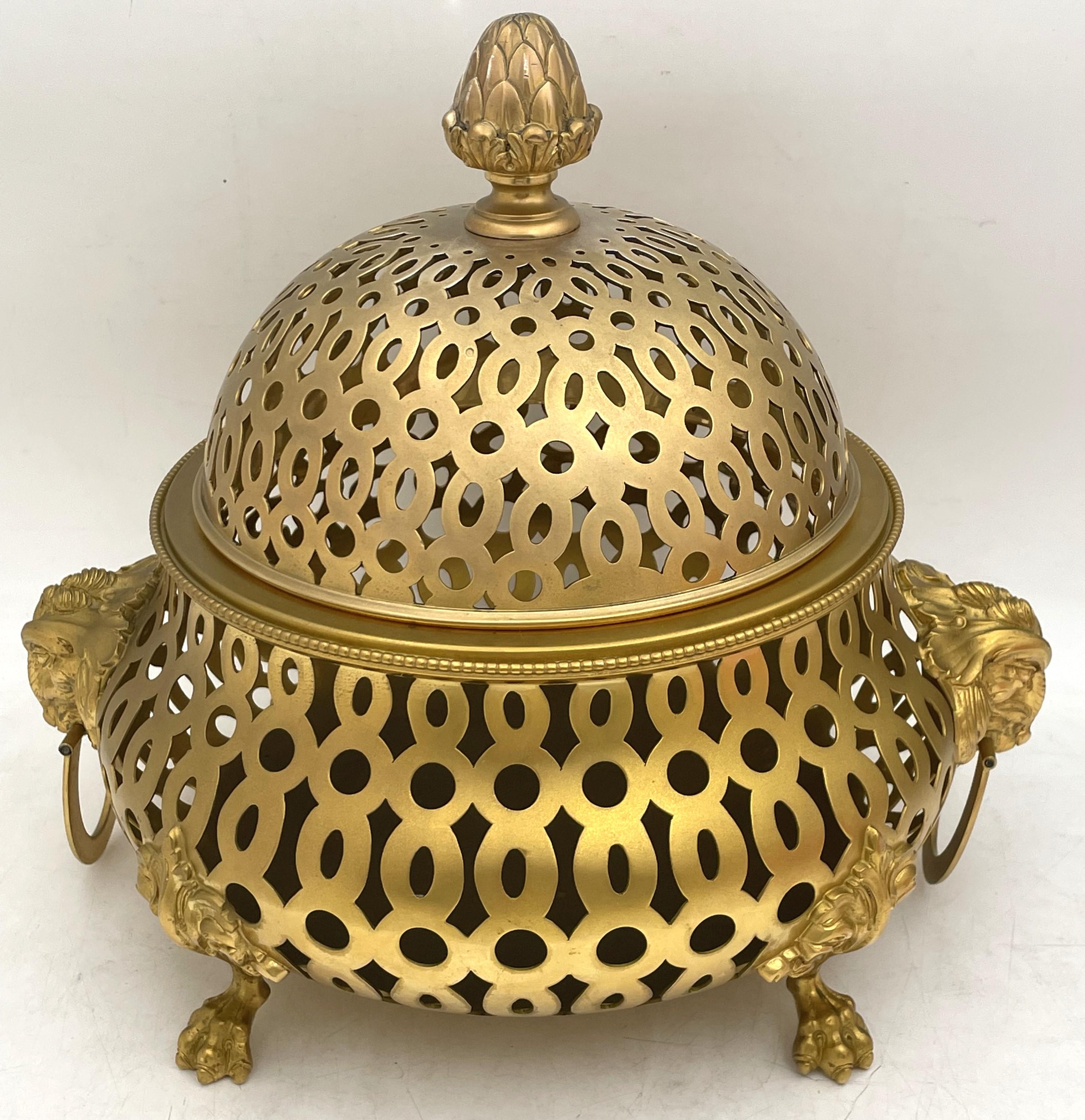 Tiffany & Co. rare gilt sterling silver rose centerpiece bowl or potpourri, beautifully adorned with a finial, two lions and with a pierced, geometric design, standing on 4 clawed feet. It was made in the mid-20th century in Italy, measures 13''