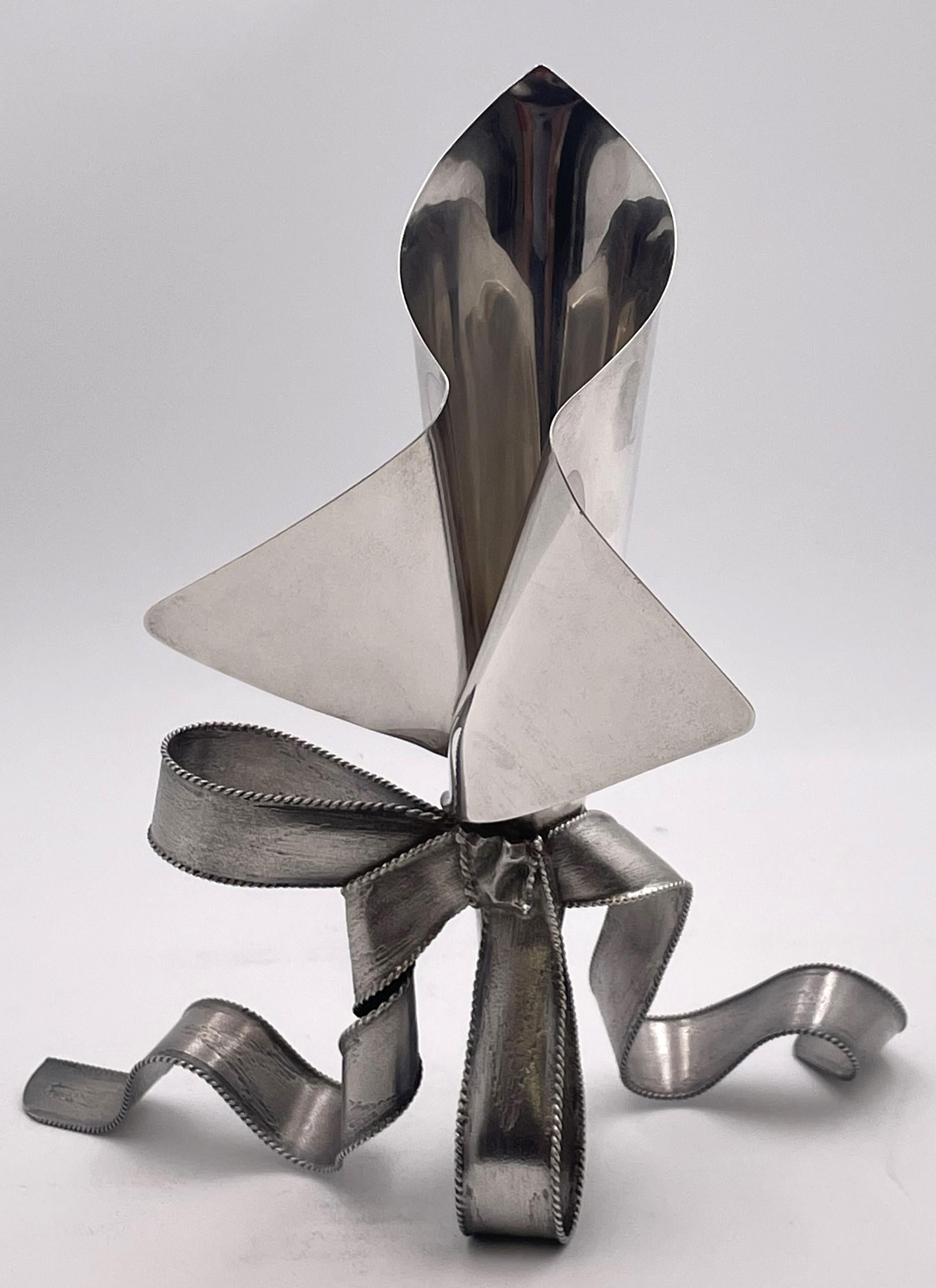 Designed by Victor Carranza and made in Mexico for Tiffany & Co., this rare vase displays a ribbon bow motif and transforms this sterling silver piece into a sculptural artwork. With elegant proportions and a geometrically inclined design, it