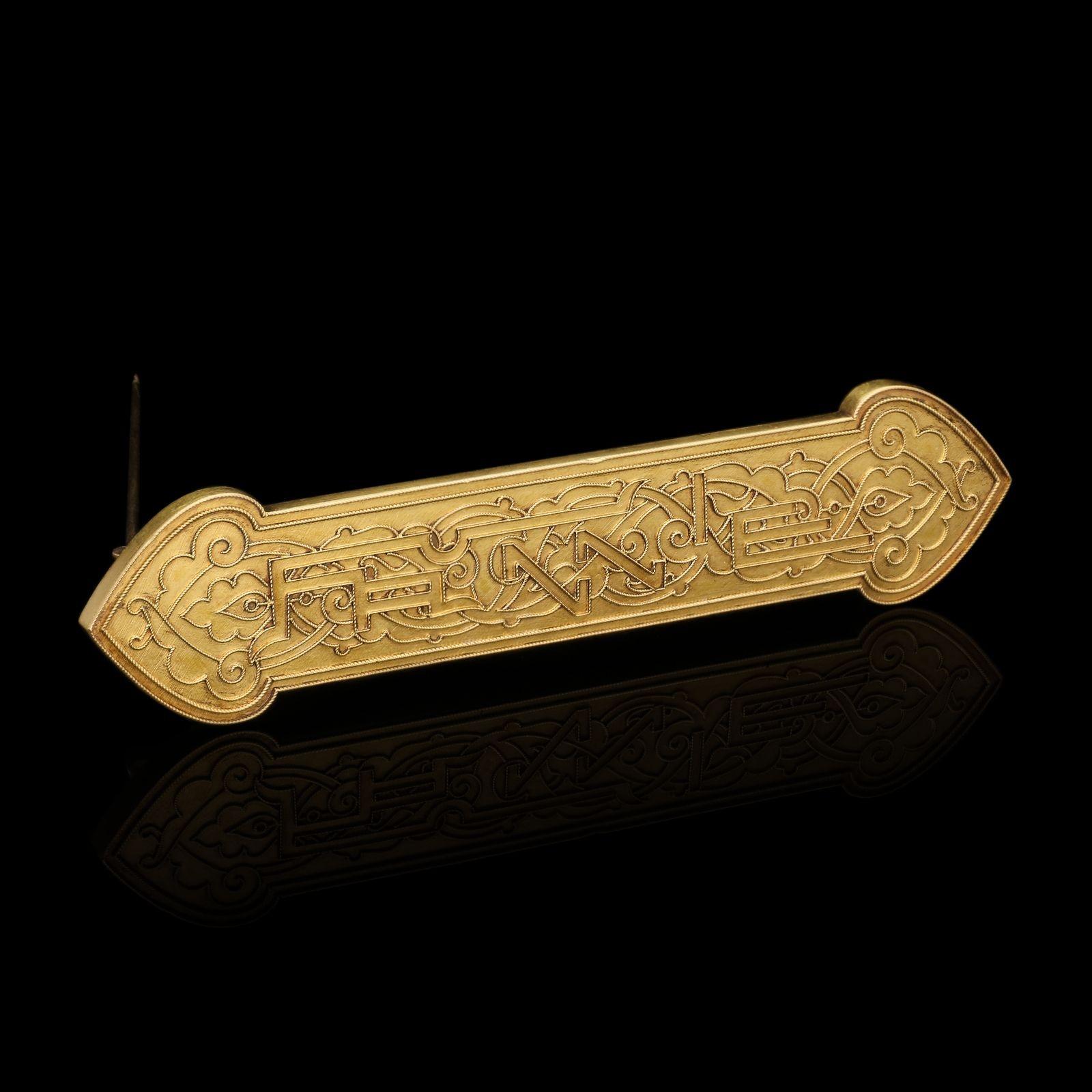 A rare and unusual gold brooch by Tiffany & Co. c.1870, the elongated rectangular shaped panel with pointed domed ends in 18ct yellow gold, finely decorated with twisted gold wirework in an Islamic inspired asymmetric pattern featuring curved and