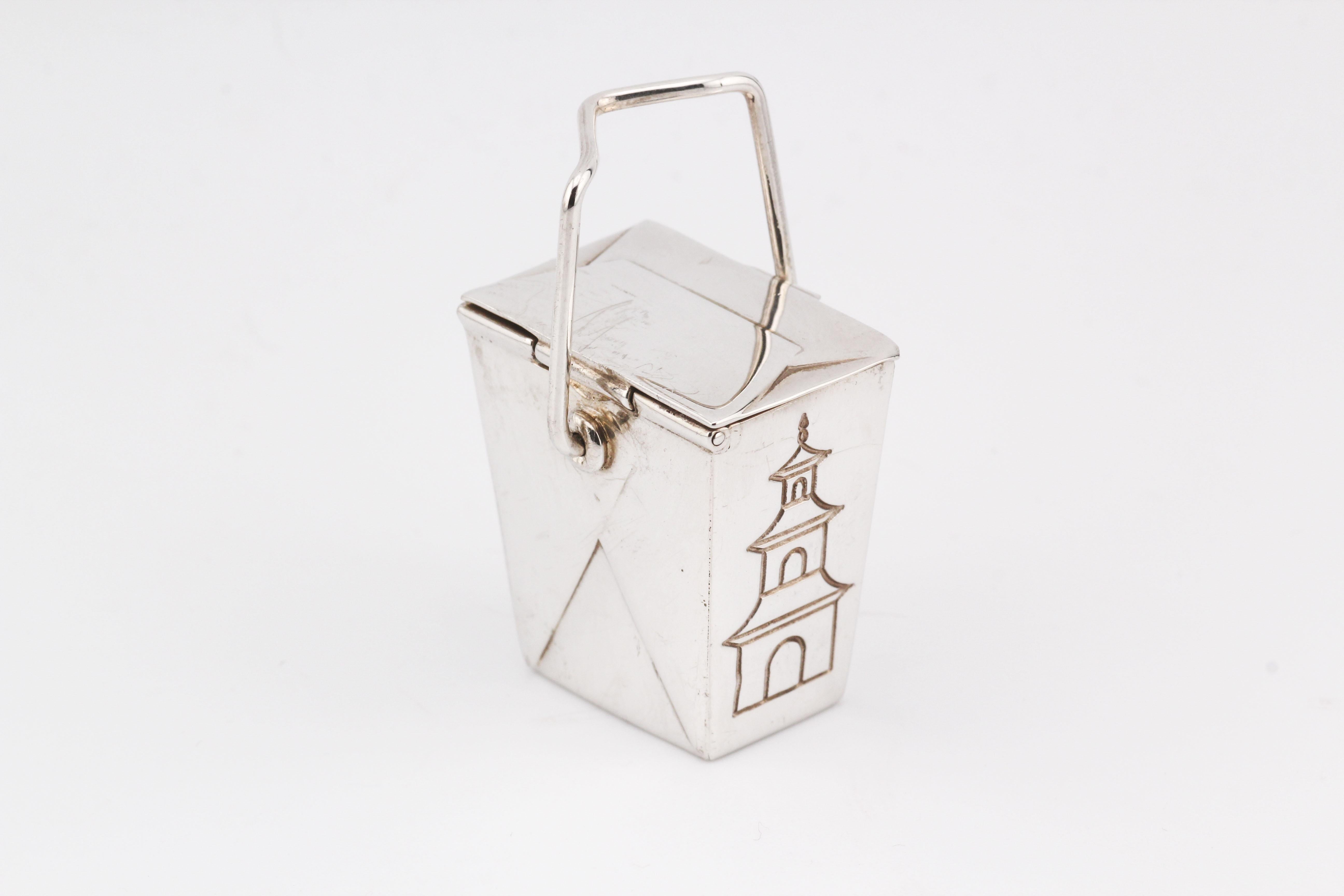 The Tiffany & Co. Rare Vintage Silver Chinese Take Out Pill Box is an extraordinary collectible that showcases Tiffany’s flair for whimsical, expertly crafted designs. Shaped like a traditional Chinese takeout box, this pill box is meticulously