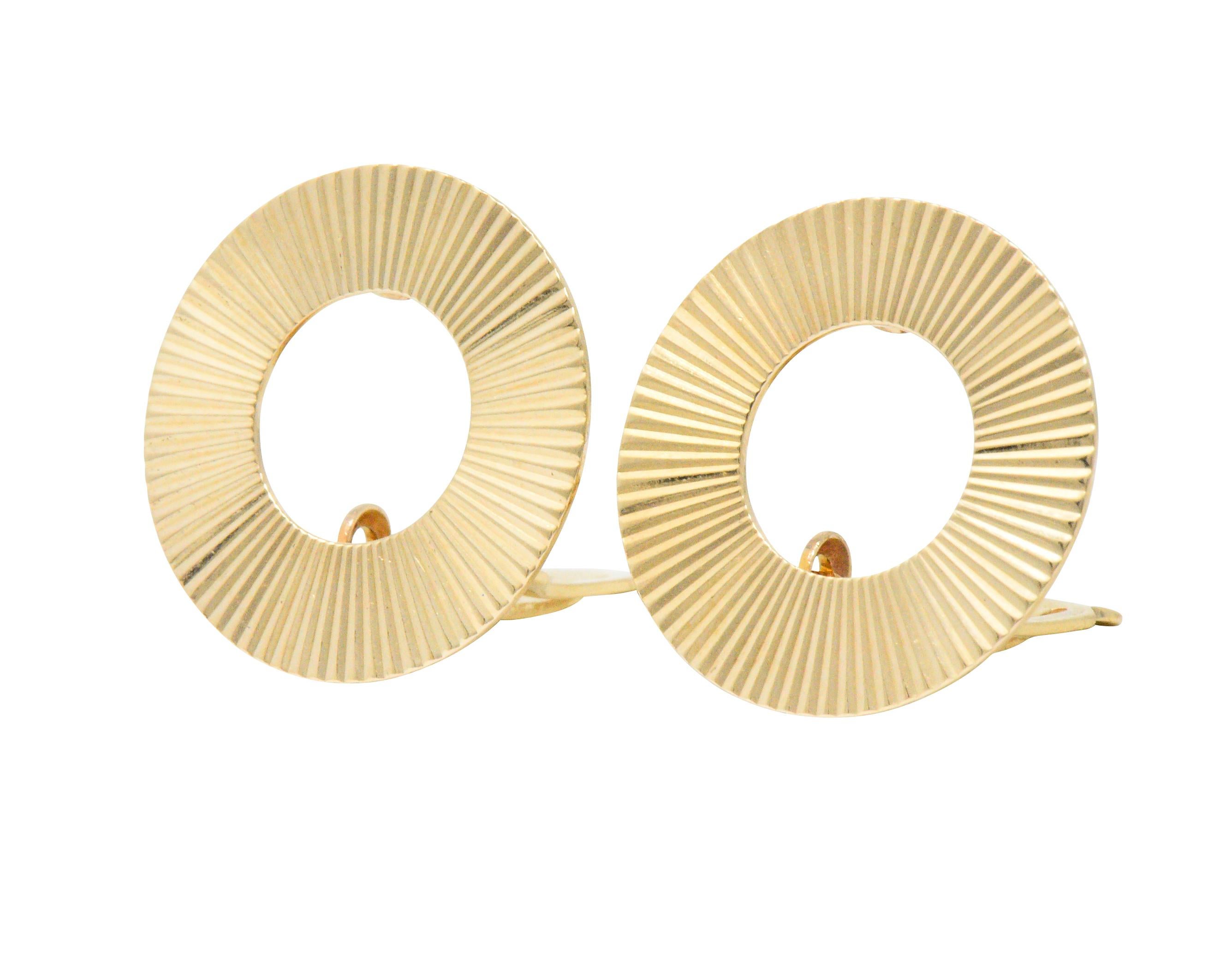 Designed as ribbed highly polished gold, open circles

Fully singed Tiffany & Co.

Hinged clip backs

Diameter: 3/4 Inch

Total Weight: 5.3 Grams

Classic. Bright. Clean. 

We- 1706