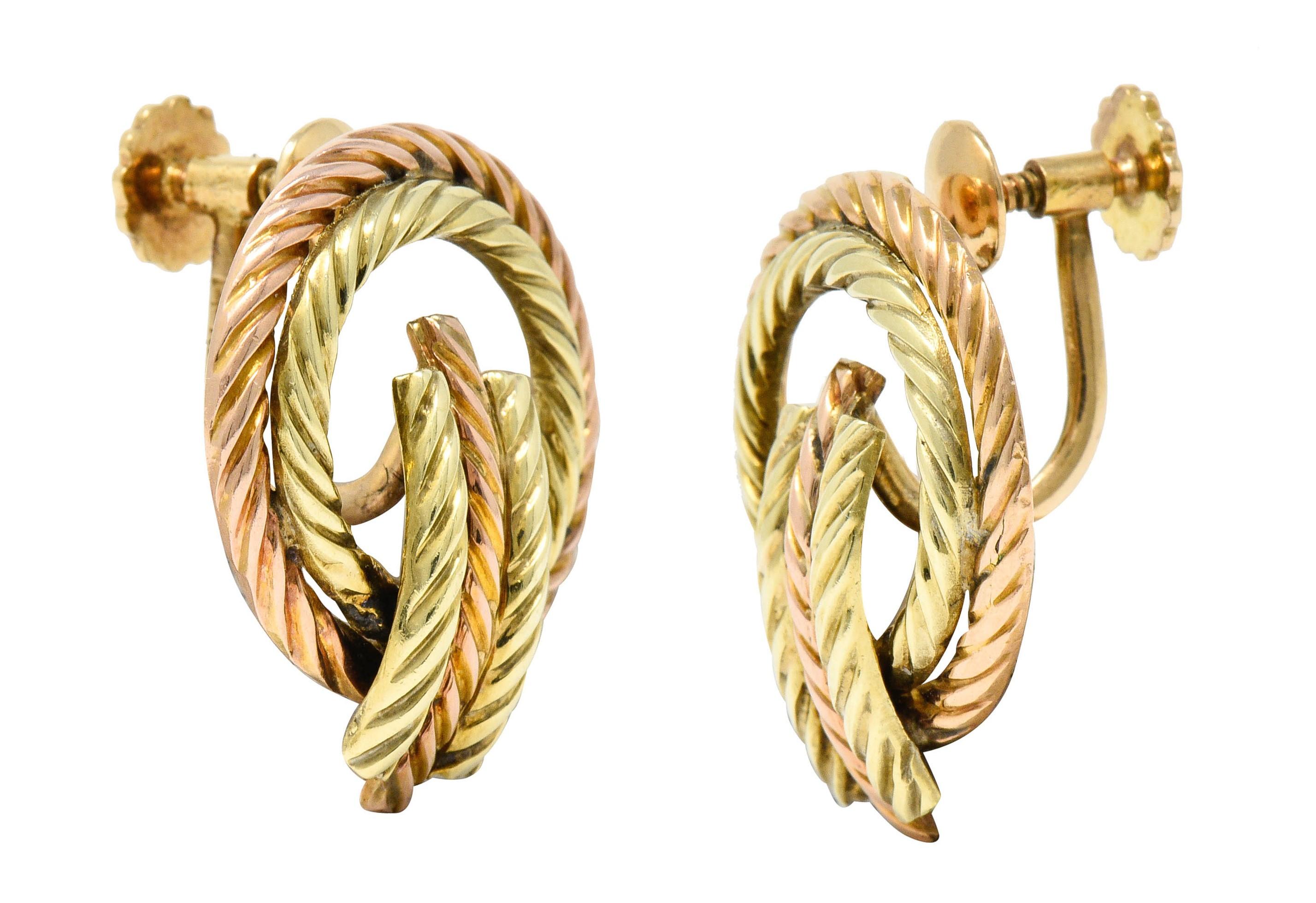 Earrings are designed as two concentric circles of rose and yellow gold
Centering a linear bar station of segmented rose and yellow gold

Entire design features a deeply grooved twisted rope motif

Completed by screwbacks

Stamped 14K for 14 karat