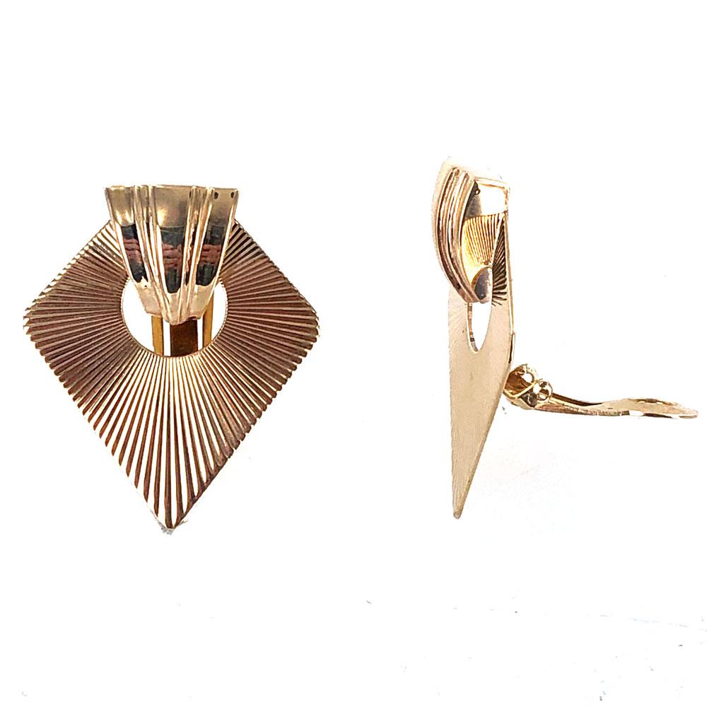 Fabulous Tiffany & Co. Retro earrings circa 1950's. The fan earrings are fashioned in 14 karat textured yellow gold and feature clip backs. The earrings measure 1.25 inches in width and 1.50 inches in length. Signed Tiffany 14K. 