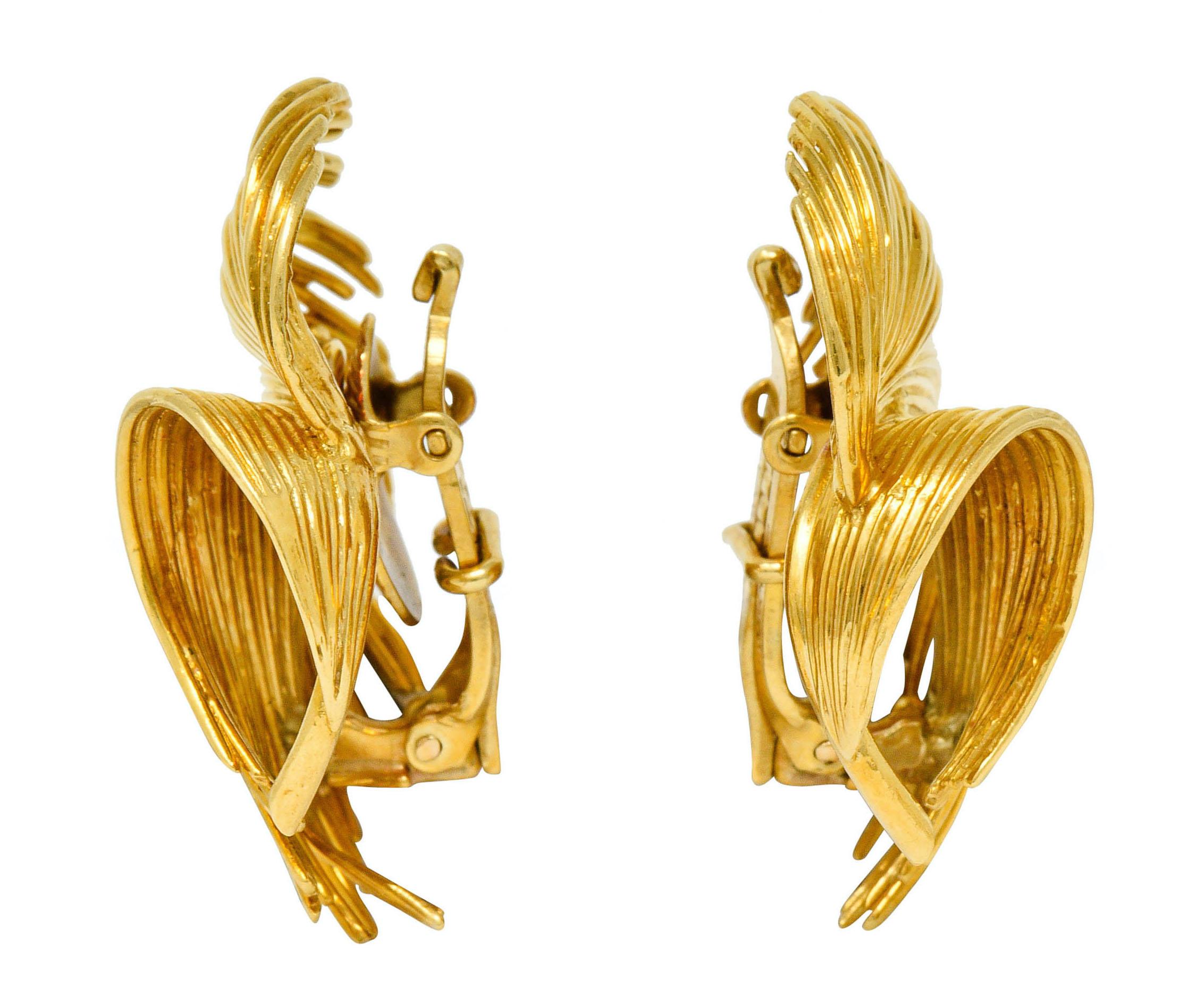 Ear-clip earrings are designed as dynamically formed feathers

Comprised of polished gold wire twisting upon itself

Completed by hinged omega backs with original patent stamp

Fully signed Tiffany & Co.

Stamped 18Kt for 18 karat gold

Circa: