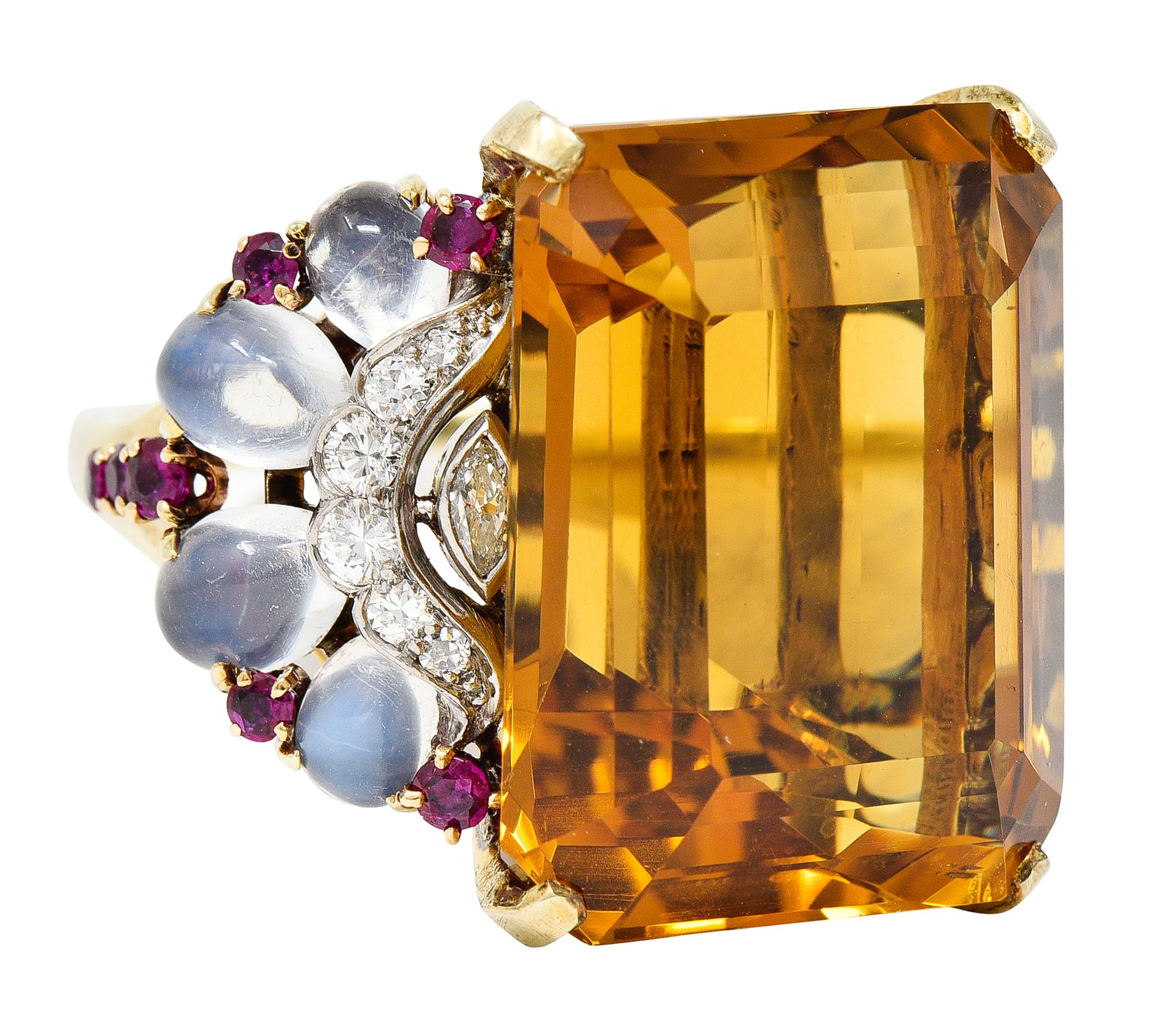 Centering an emerald cut citrine weighing approximately 38.77 carats total - transparent brownish-orange in color. Prong set in basket and flanked by transitional and marquise cut diamonds - bezel and bead set in platinum. Weighing approximately