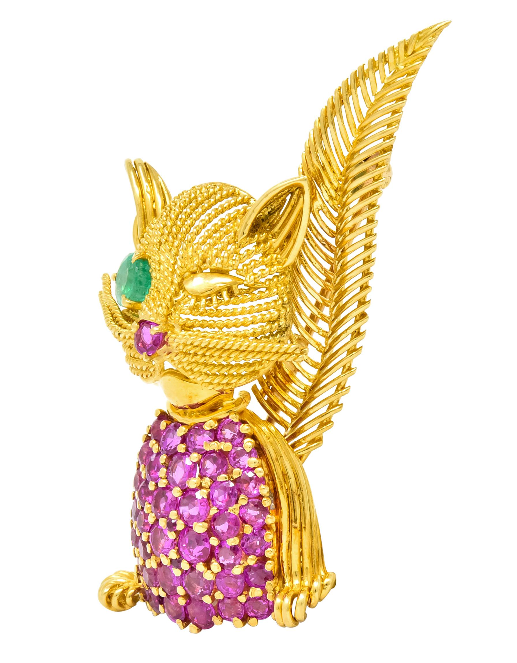 Brooch designed as a winking cat featuring textured fur and whiskers 

Set throughout with approximately 5.00 carats total of rubies, transparent and raspberry red in color

Accented by a round cut emerald eye weighing approximately 0.45 carat,