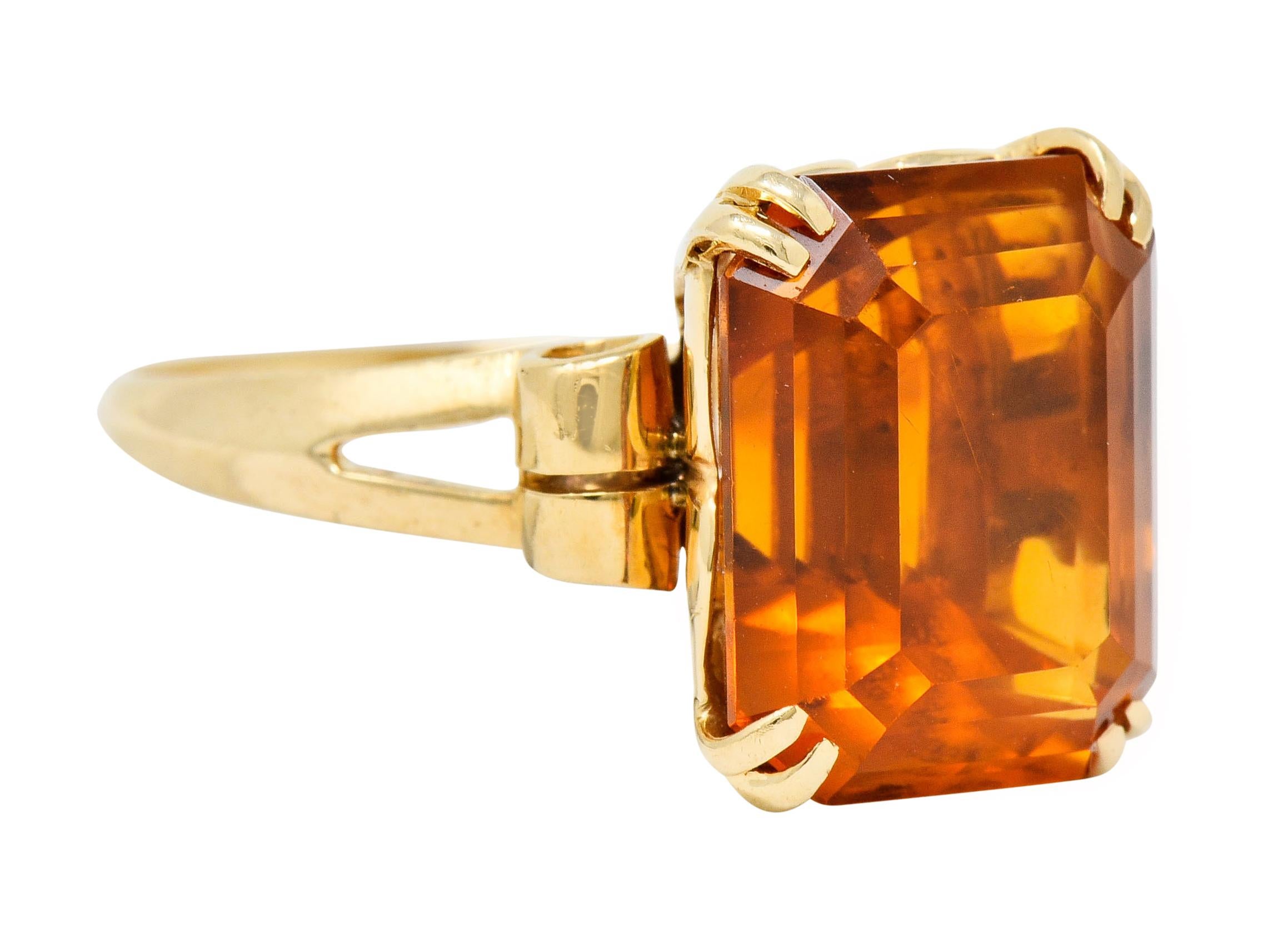 Centering a rectangular step cut citrine weighing 7.25 carats, transparent with a deep rich orange color

Set by split prongs in a decorative basket and is completed by scrolled shoulders

Signed Tiffany & Co. 

Ring Size: 7 & sizable

Measures: