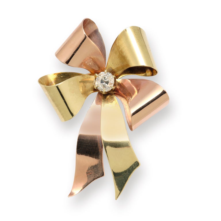Tiffany & Co Retro Old Mine Diamond and Two Tone Gold Ribbon Brooch

Round cut diamond set in the center of a 14k rose and yellow gold ribbon 

Measurements: 2