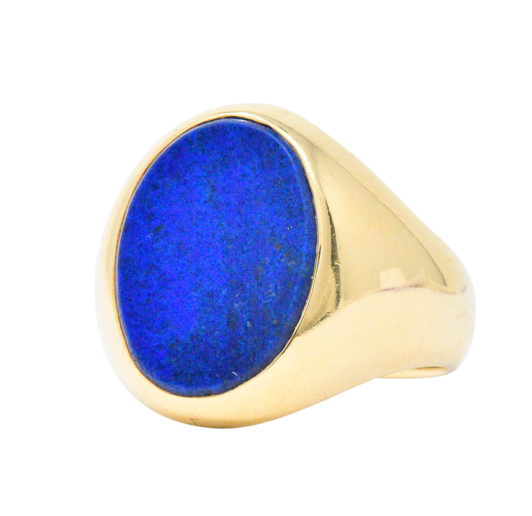 Centering a flat oval lapis measuring approximately 15.8 x 12.1 x 2.4 mm. bright royal blue

Bezel set in a high polished gold mount

Fully signed Tiffany & Co. with maker's mark for Larter & Sons

Ring Size: 8 1/4

Top measures 18.4 mm and sits 2.6