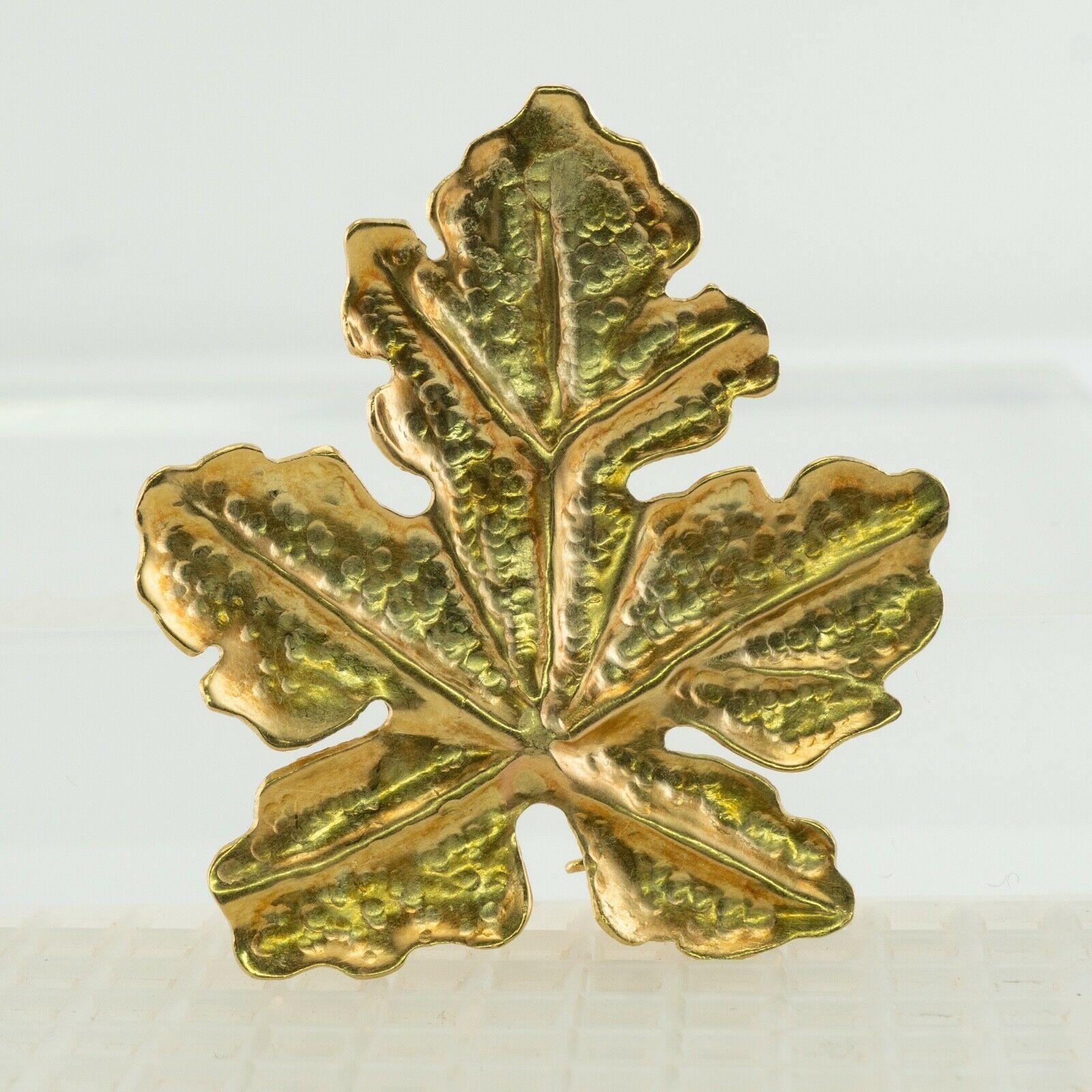 This authentic Tiffany and Co. brooch pin is crafted in solid 18K Yellow Gold. 
It is made in the shape of leaves. 
The leaf 1-5/16