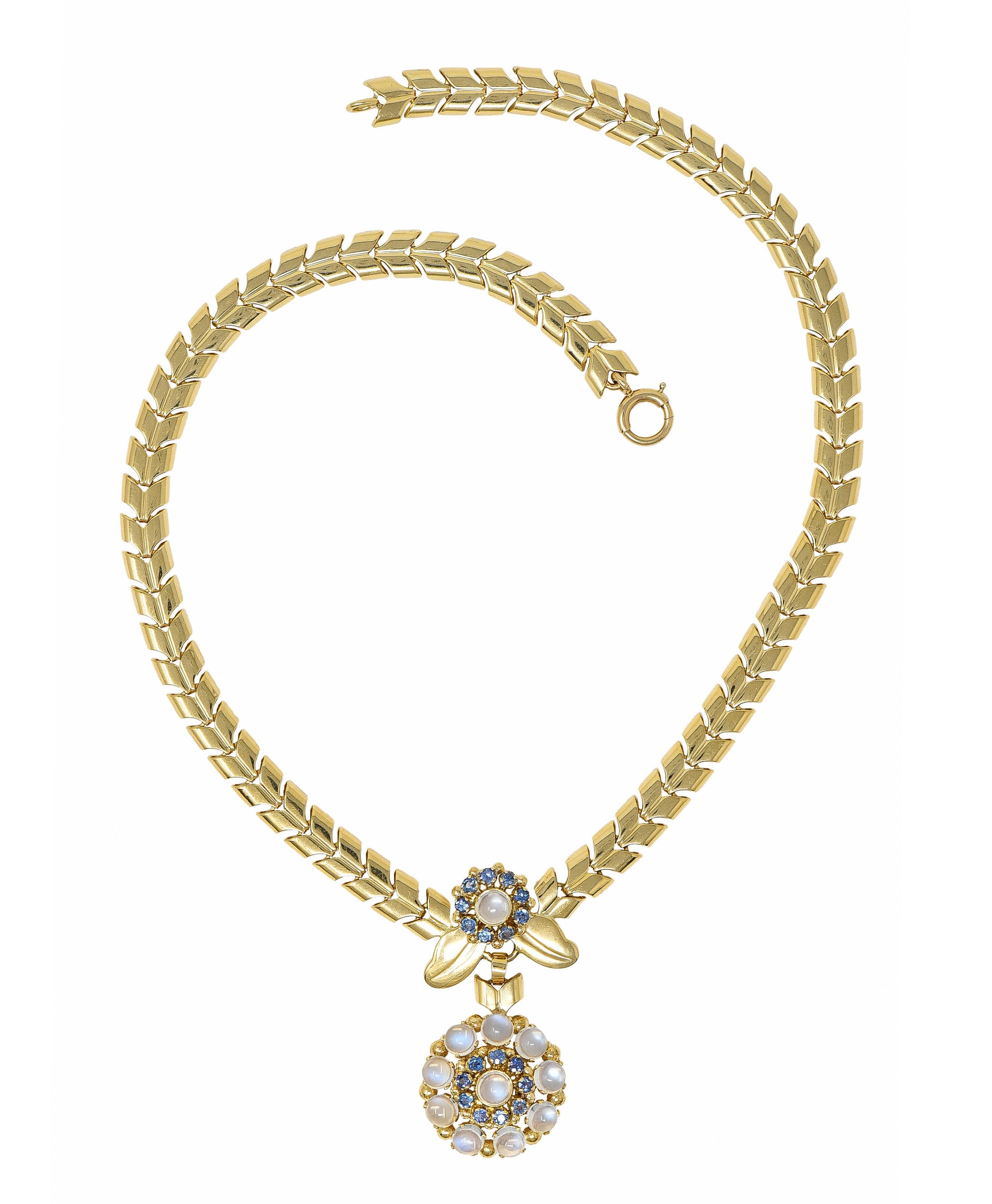 Necklace is comprised of polished chevron links terminating as a spring ring clasp

Featuring a center station comprised of two radiating floral clusters flanked by stylized gold foliate

With 4.5 mm round moonstone cabochons - translucent with