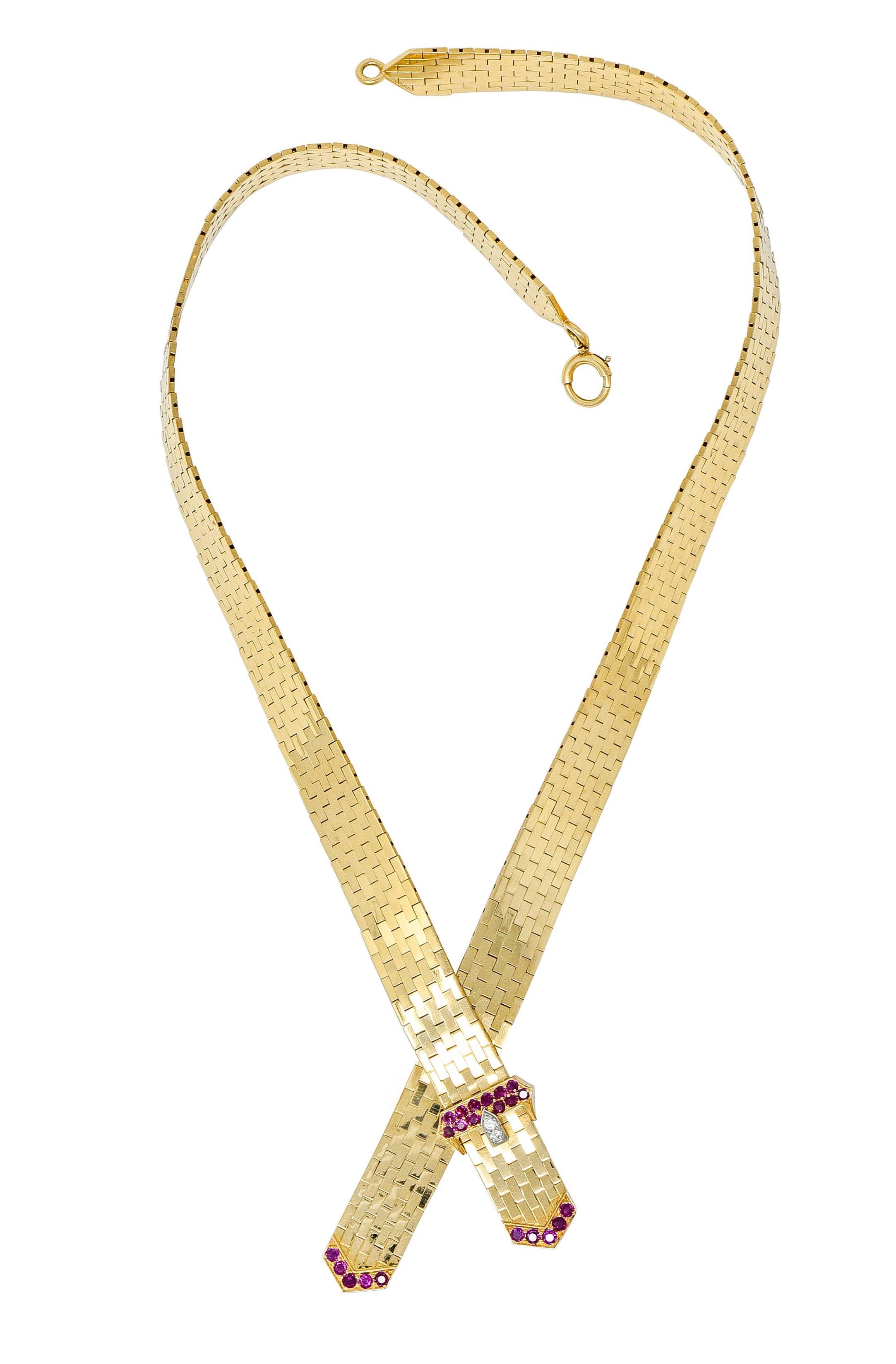 Collar necklace is comprised of polished gold brick links, incredibly malleable

Centering a buckle motif with two suspended tails

Accented by round cut ruby and round brilliant cut diamonds; purplish-red and bright white

Weighing in total