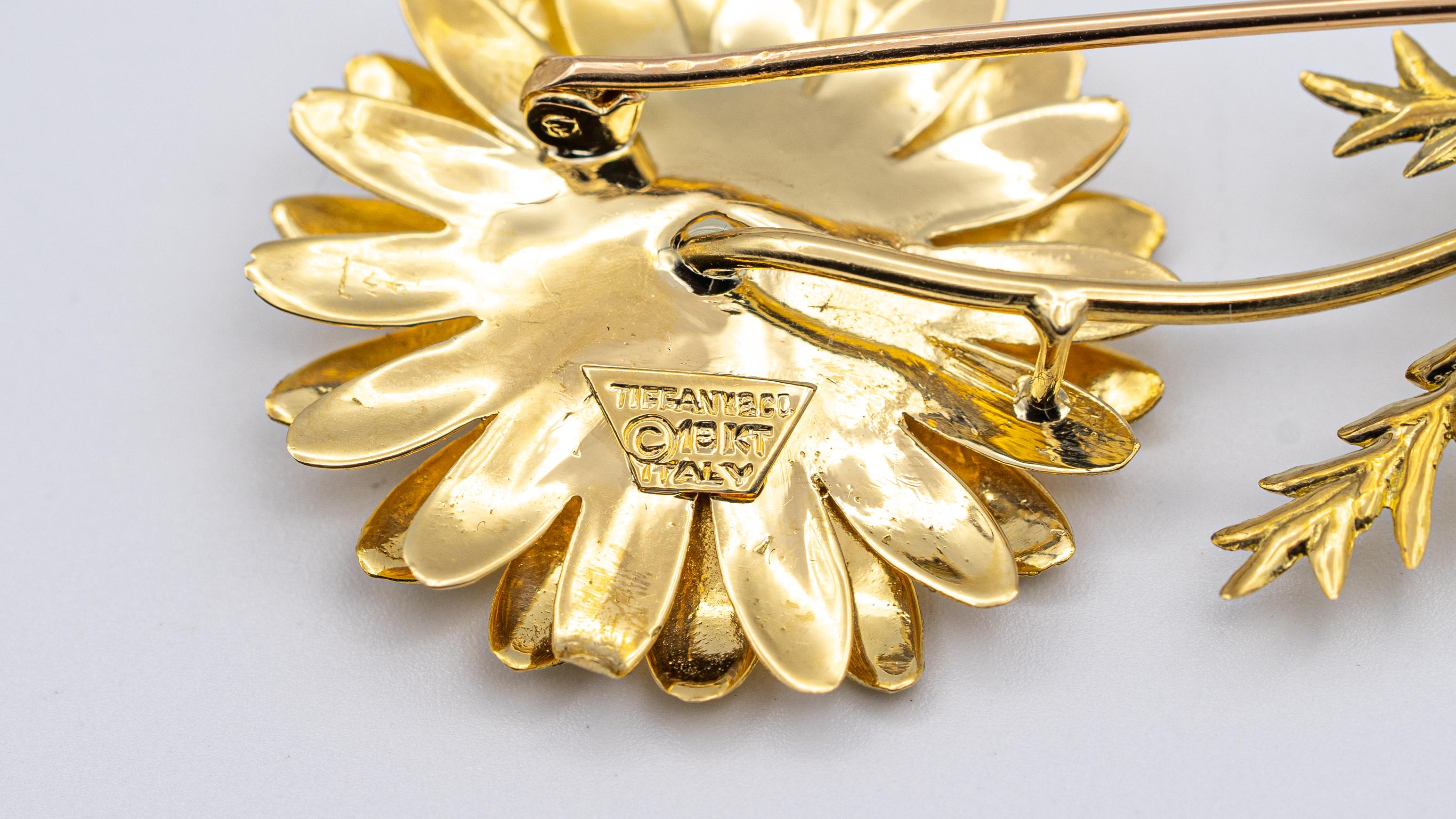 Vintage Tiffany & Co. Ruby cluster brooch finely crafted in 18 Karat yellow gold. 7 raspberry red rubies weigh 0.30 carats total weight approximately.

Hallmarks: Tiffany & Co. , 18KT, Italy 
Measurements: L: 2.5