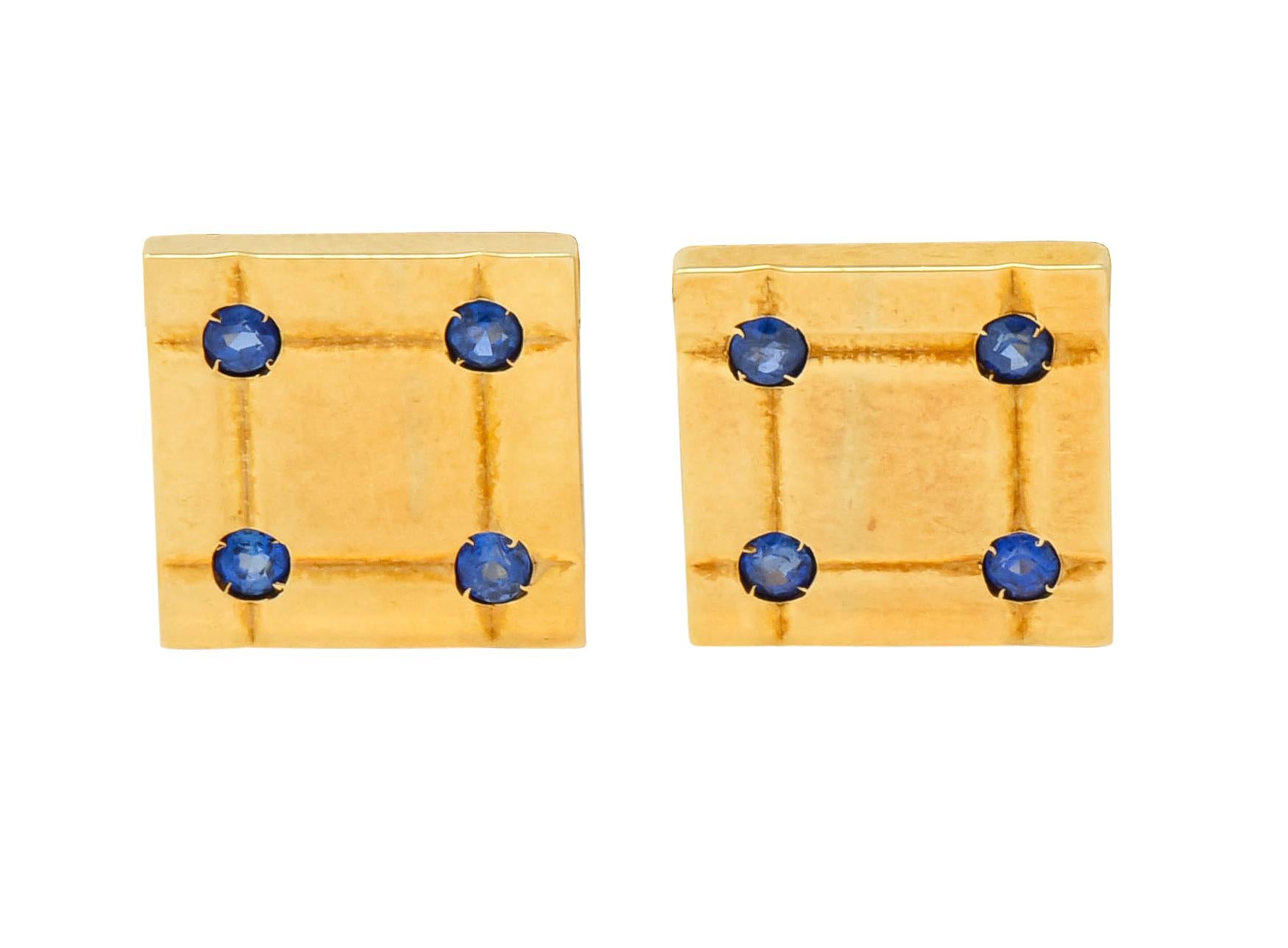 Lever style cufflinks designed as a deeply grooved polished square

With three matching, spring loaded, bar shirt studs

Each accented by four round cut sapphires weighing approximately 0.96 carat total, very well-matched and a bright denim blue