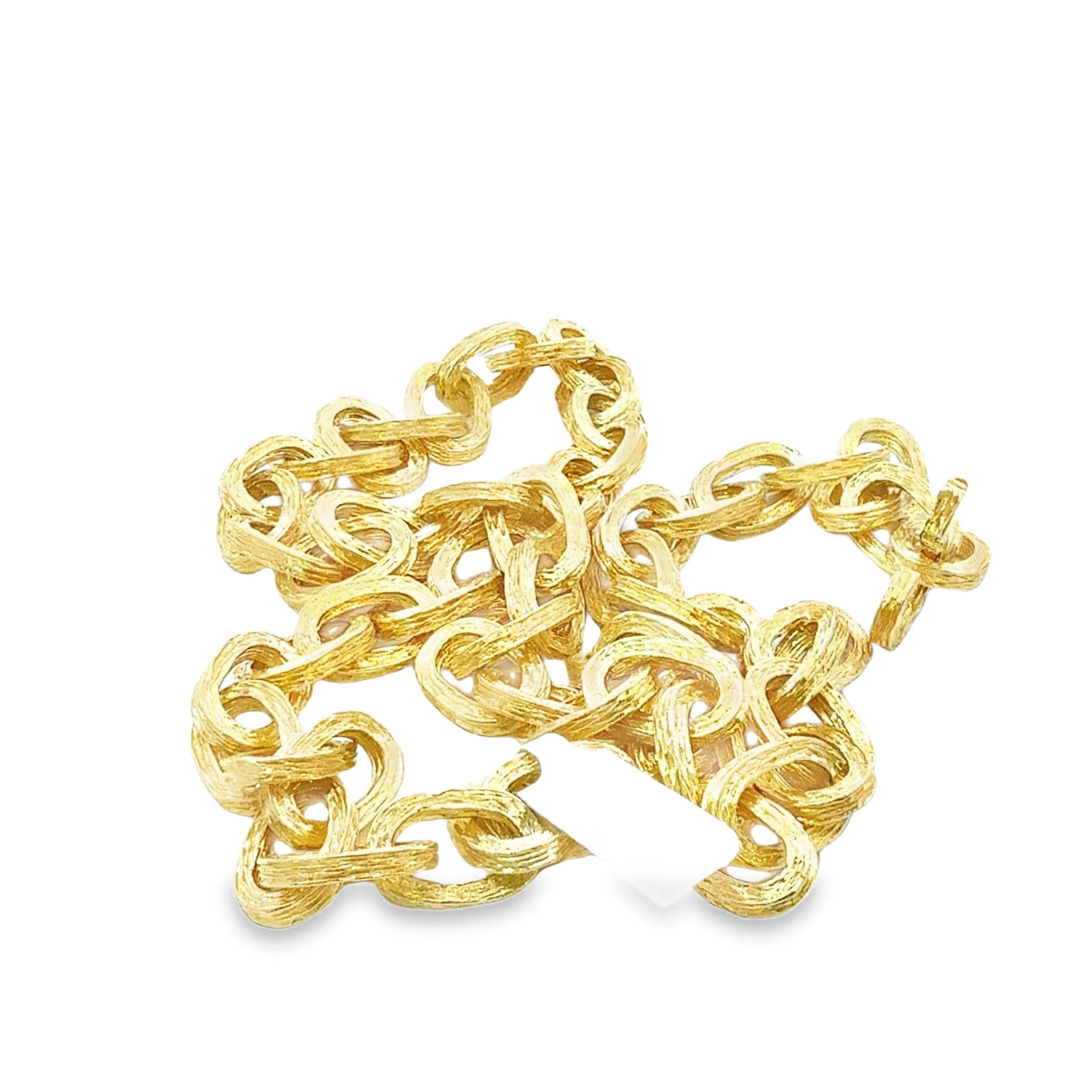 This Tiffany & Co. 18k yellow gold retro vintage chain necklace features bold interlocking links in a sophisticated, textured finish—perfect for collectors of fine vintage Tiffany & Co. jewelry. Crafted in solid 18k yellow gold and weighing an