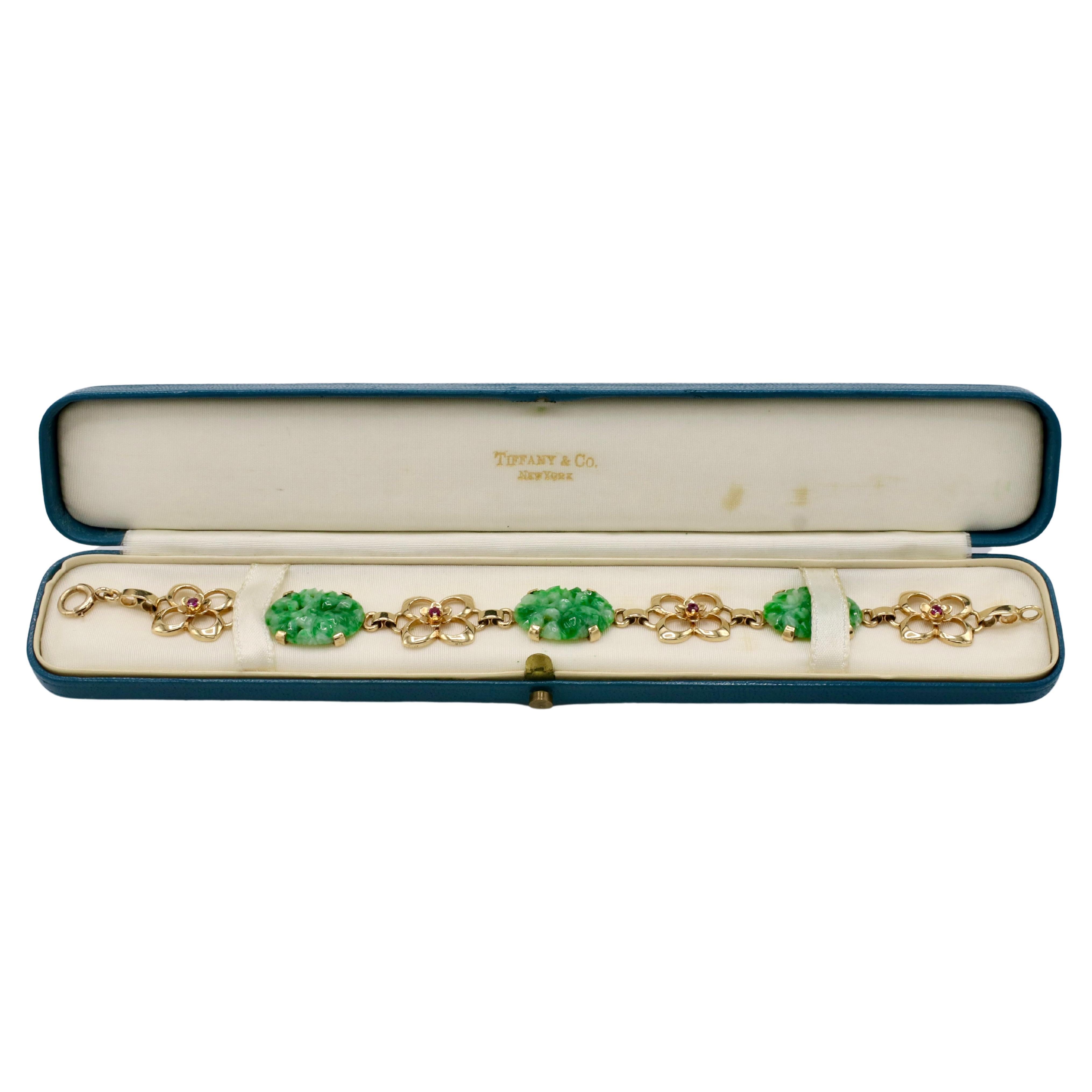 Tiffany & Co. Retro Yellow Gold Carved Jade & Ruby Flower Station Bracelet 
Metal: 14k yellow gold
Length: 7.5 inches
Width: 15mm
Weight: 19.3 grams
