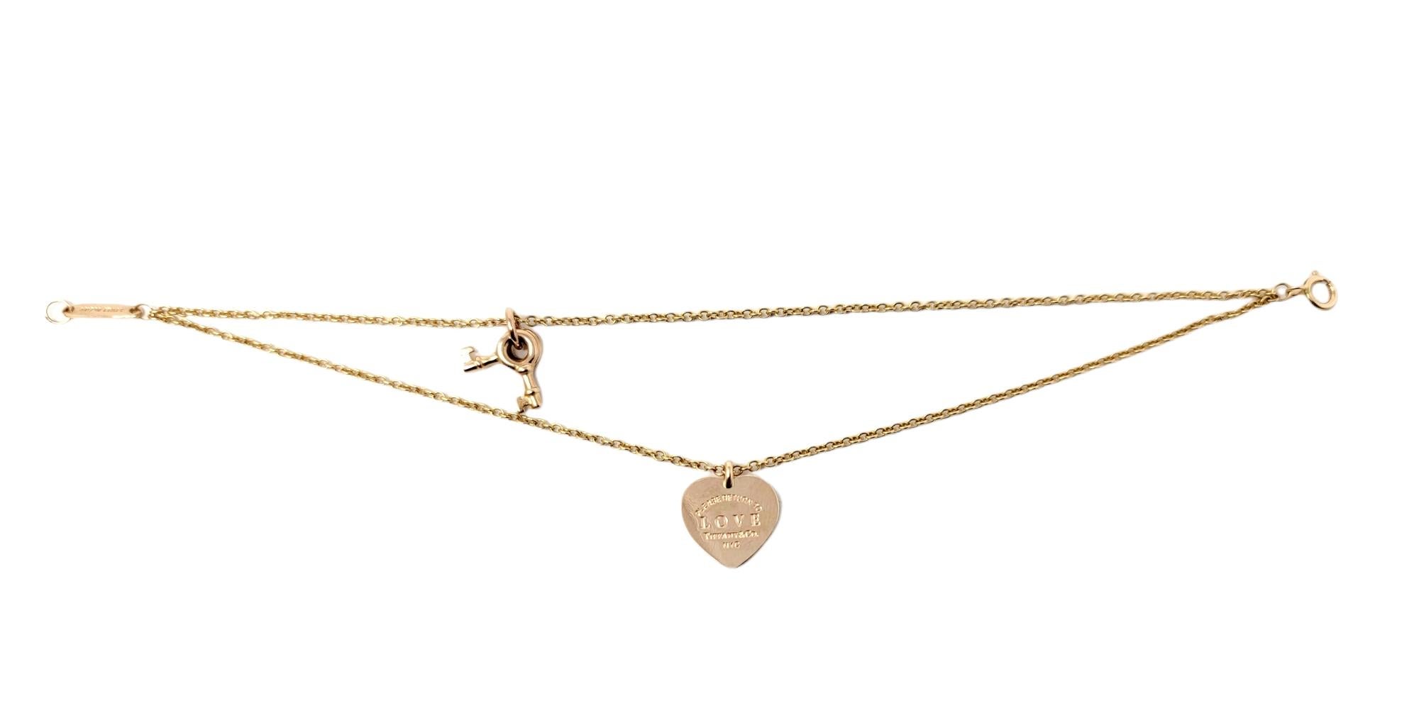 You will love this dainty and feminine double chain bracelet by Tiffany & Co.. Featuring a heart tag and 2 skeleton keys, this delicate 18 karat rose gold beauty is simple yet stunning. 

Metal: 18K Rose Gold
Weight: 5.4 grams
Bracelet Length:
