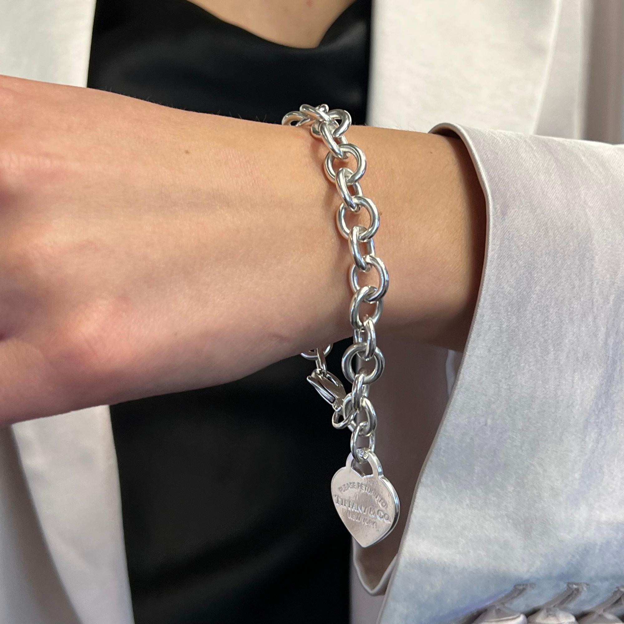 With a truly elegant design, this bracelet embodies the collection's celebrated aesthetic. Designed in sterling silver 925. This corner hanging heart tag charm comes with engraving on the front and stamped on the back. Secured with lobster lock