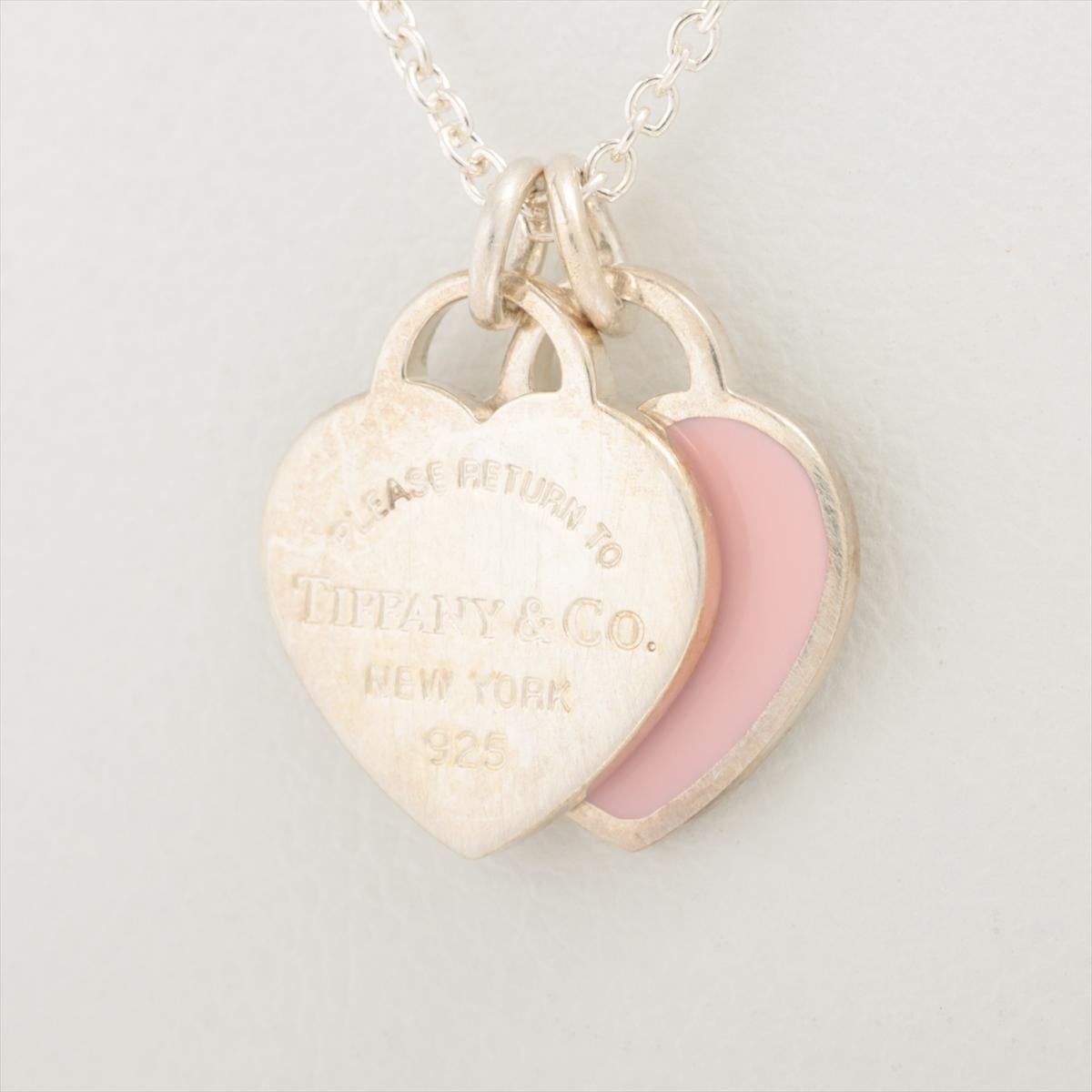 The Tiffany & Co. Return To Tiffany Mini Double Heart Tag Necklace in Pink is a delicate and charming piece of jewelry that exudes elegance and sentiment. The necklace features a double heart pendant. The hearts are beautifully crafted from