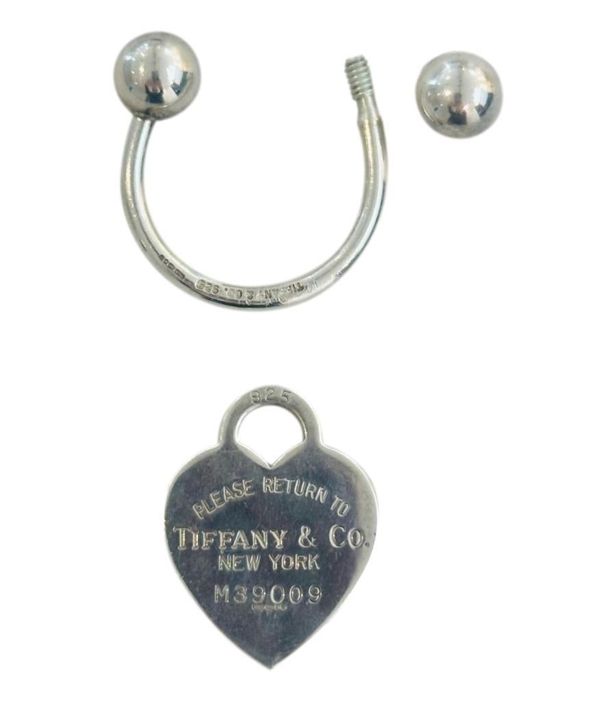 Tiffany & Co 'Return To Tiffany' Sterling Silver Key Ring

The iconic Love Heart engraved with 'Return To Tiffany'

Half hoop with sphere ends, with one that screws off, which enables

you to add your keys,.

Size - One Size

Condition - Good (Some