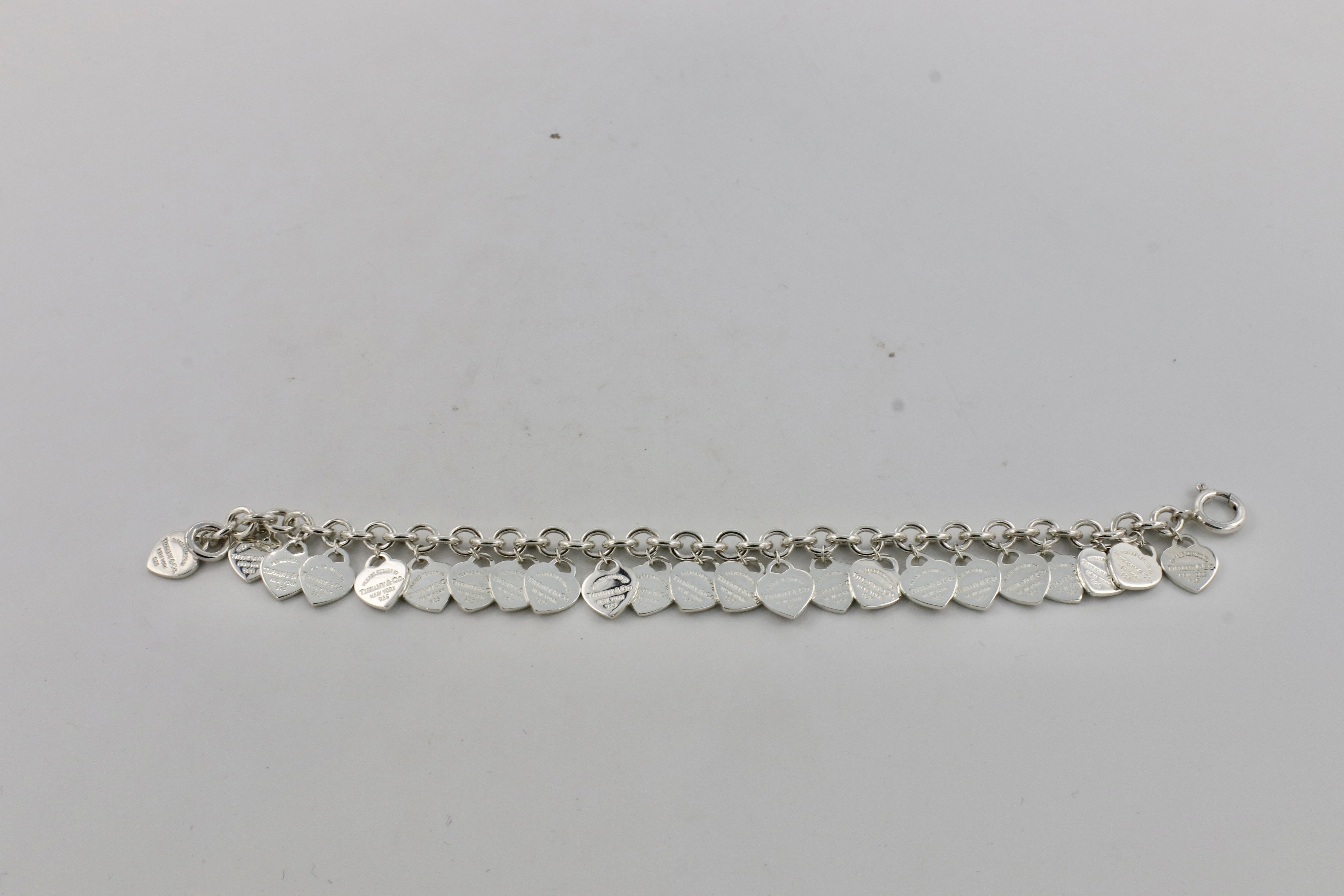 Tiffany & Co. Return to Tiffany Sterling Silver Multi Heart Charm Link Tag Bracelet 
Metal: Sterling silver 925
Weight: 33.7 grams
Length: Size medium, 7.5 inches 
Hearts: 23 charms
Signed: Please Return to Tiffany & Co. New York 925 ©T&Co. Ag925