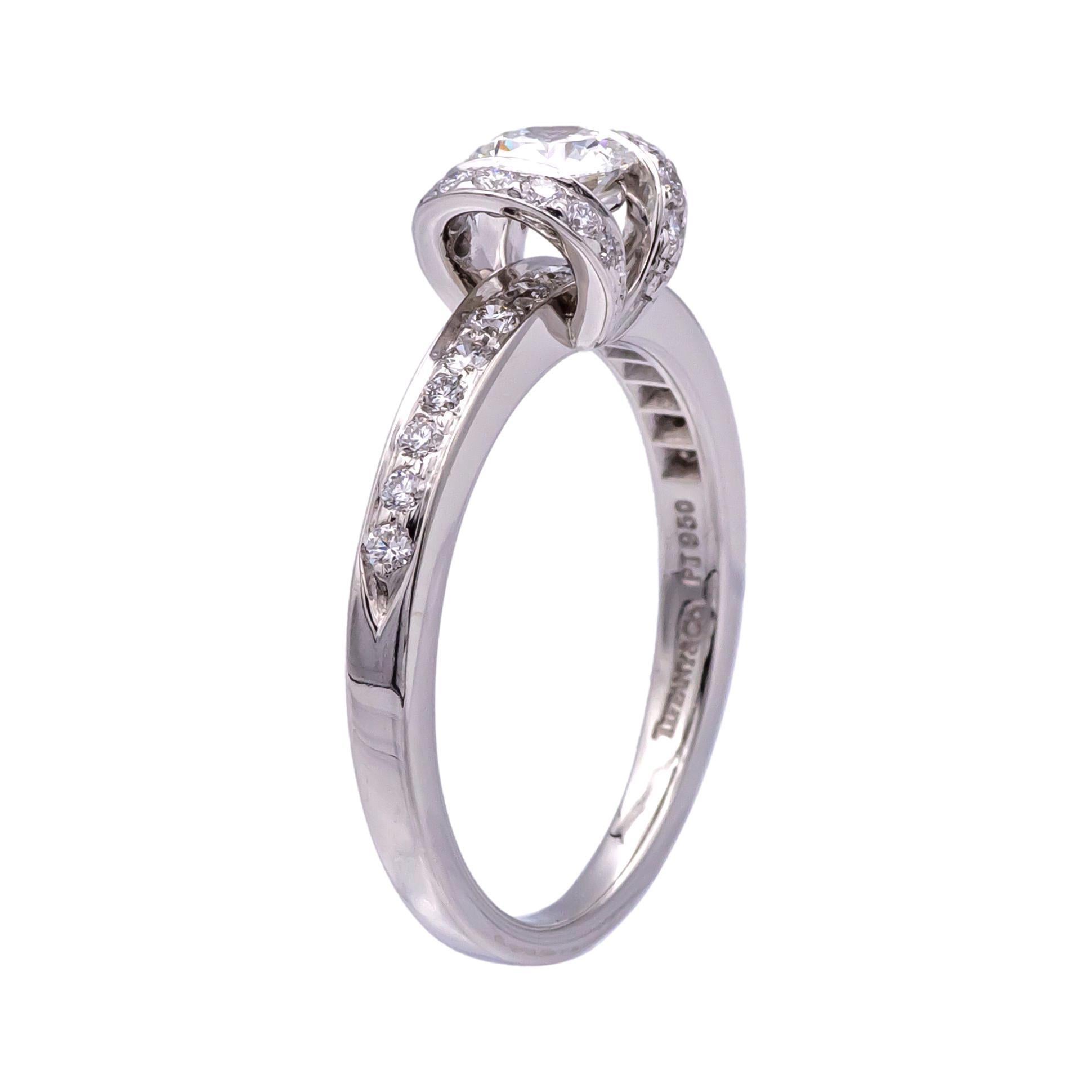 A 1999 Tiffany & Co Ribbon Diamond ring featuring a .42 ct Center H VS1 diamond.  The diamond is set in Tiffany's Ribbon style ring, which is adorned with an additional 29 diamonds , E-G Color , VS clarity, weighing a total of .30cts.  Included with