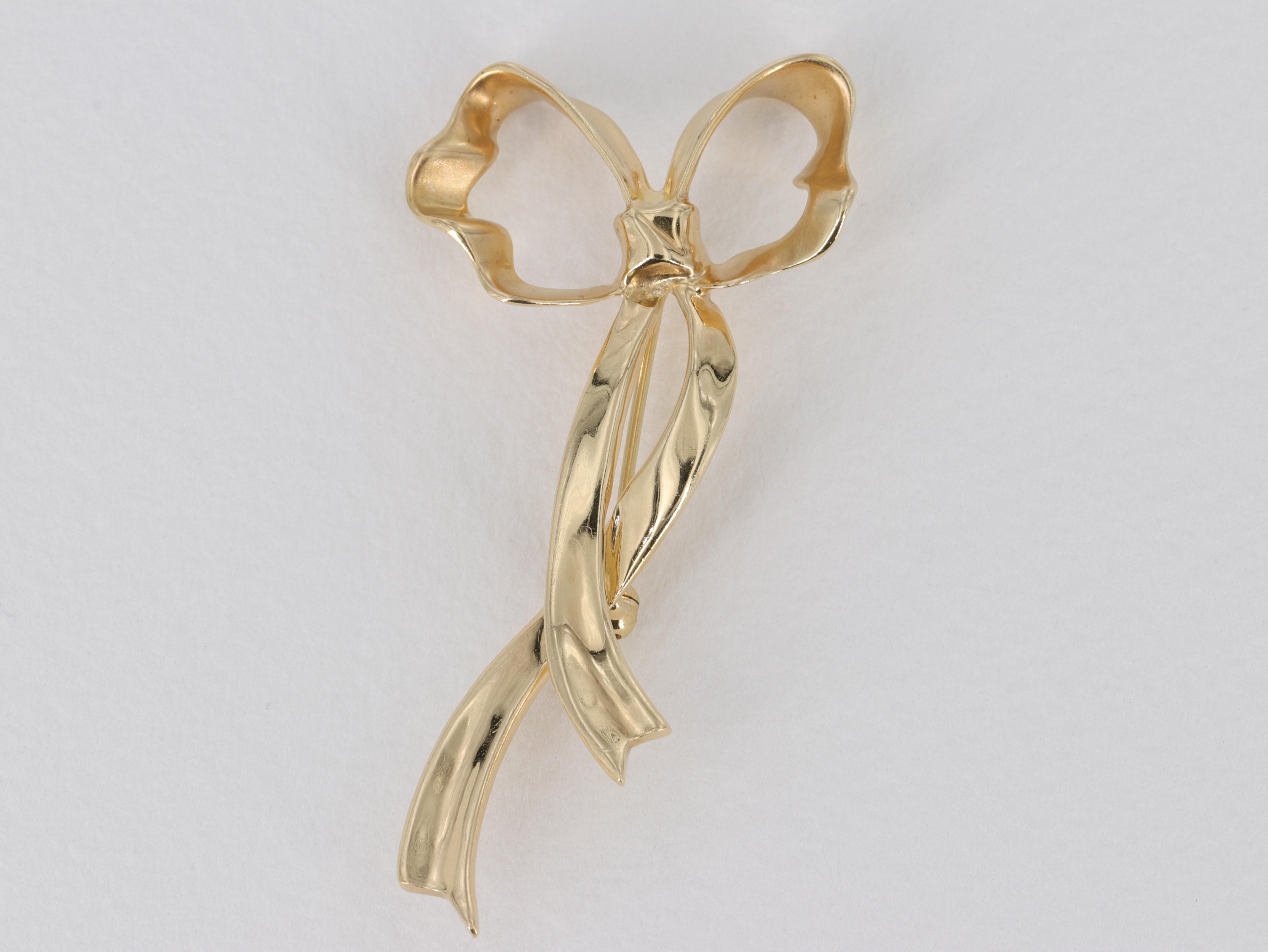 Tiffany & Co. Ribbon Bow Brooch in 18 Karat Yellow Gold 

    Brooch:
       Metal - 18k Yellow Gold 
       Weight - 8.2 Grams  
       Dimensions - 2 x 1 in
       Hallmarks - 1985/ Tiffany & Co / 750 