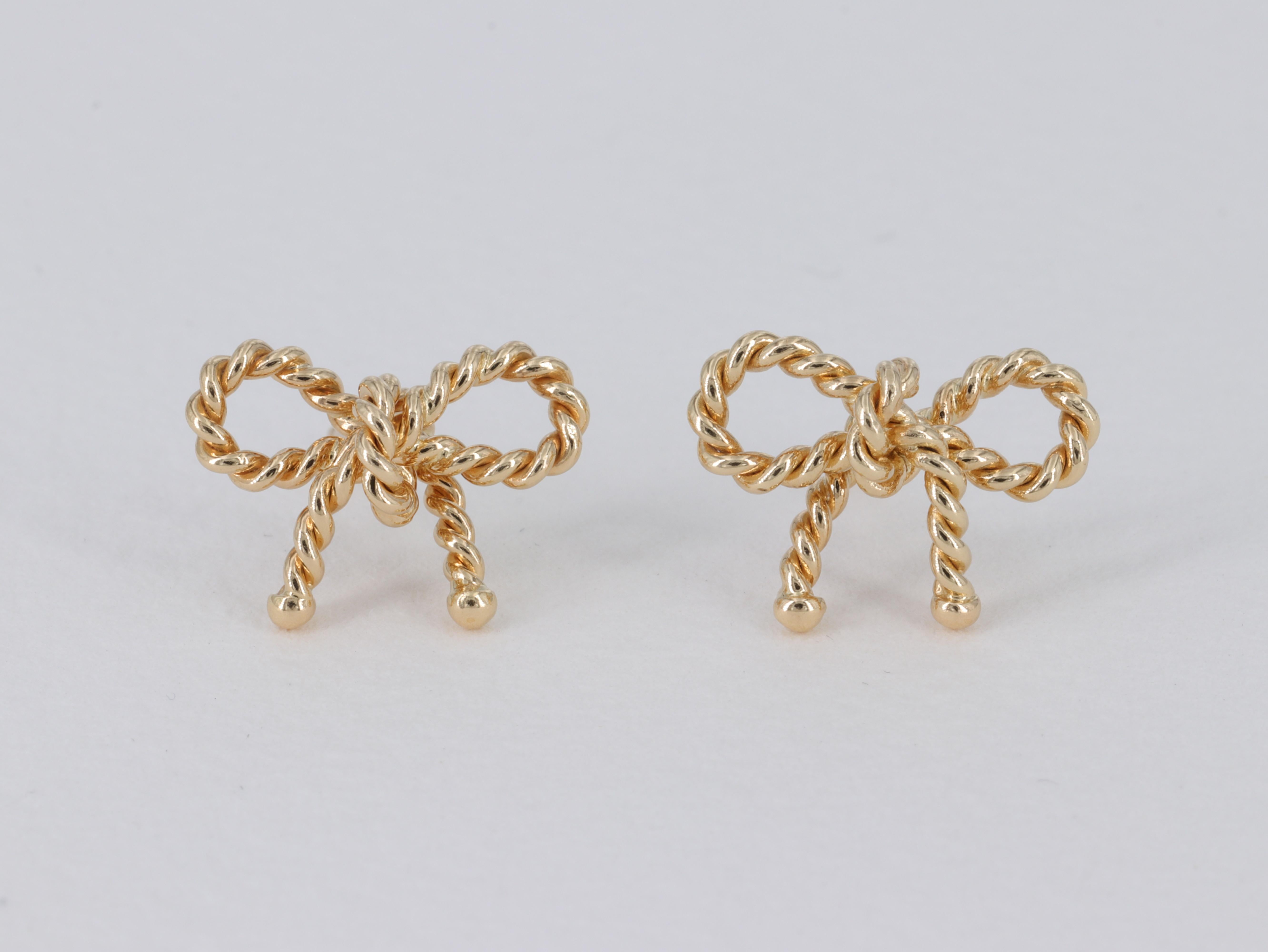 A cute and dainty pair of Tiffany & Co. rope bow earrings crafted in solid 18 karat yellow gold, just the right size and the perfect addition to a day at the beach or on the boat. 

Looking for a set?

We also have in stock a matching Tiffany and Co