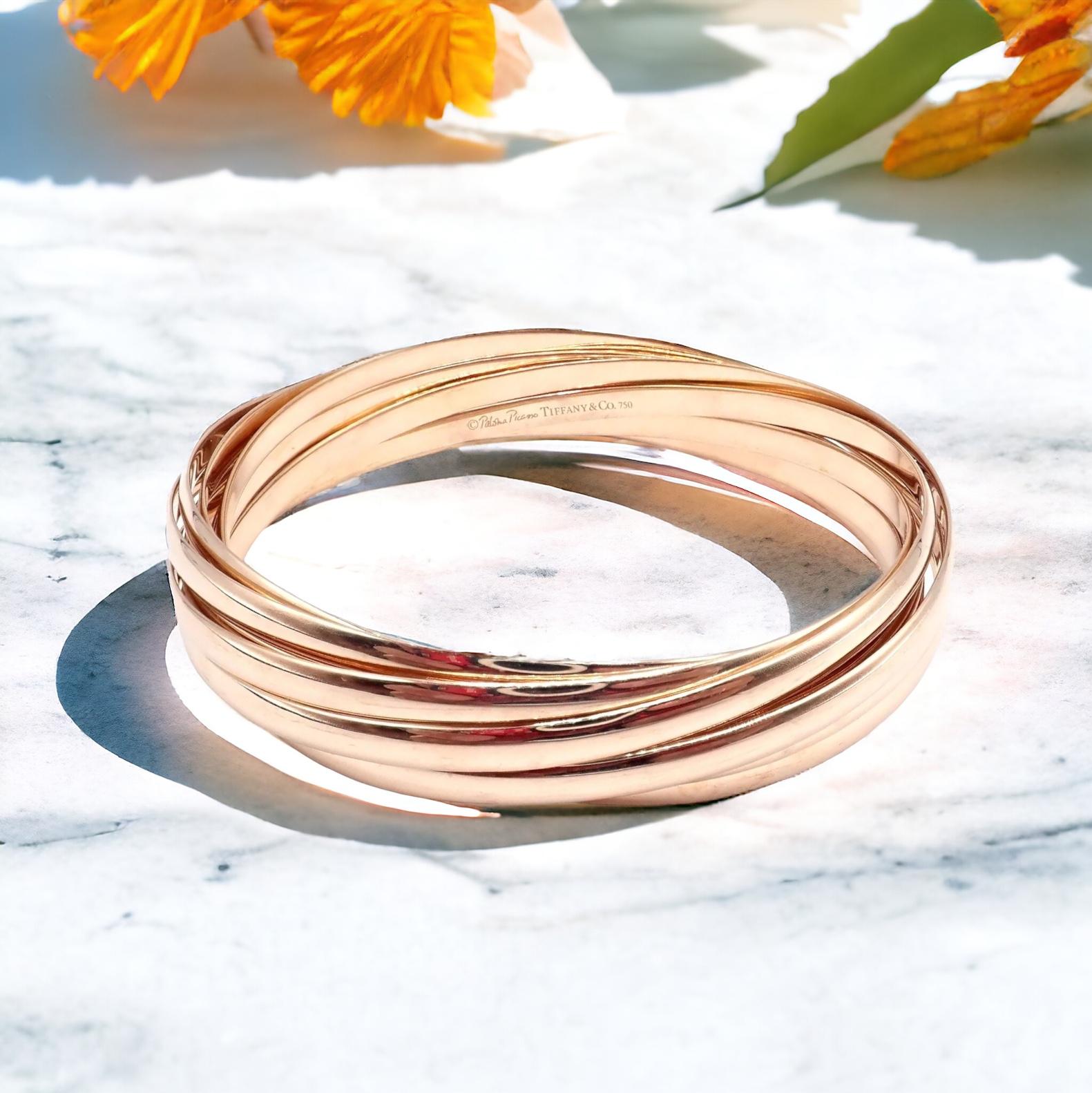 18k Yellow Gold 9 Row Paloma Picasso Melody Calife Bracelet by Tiffany & Co.

Indulge in the splendor of this Authentic Tiffany & Co 18k Rose Gold 9 Row Melody Calife Picasso Bracelet. 

This exquisite piece, a creation of Picasso’s romantic period,