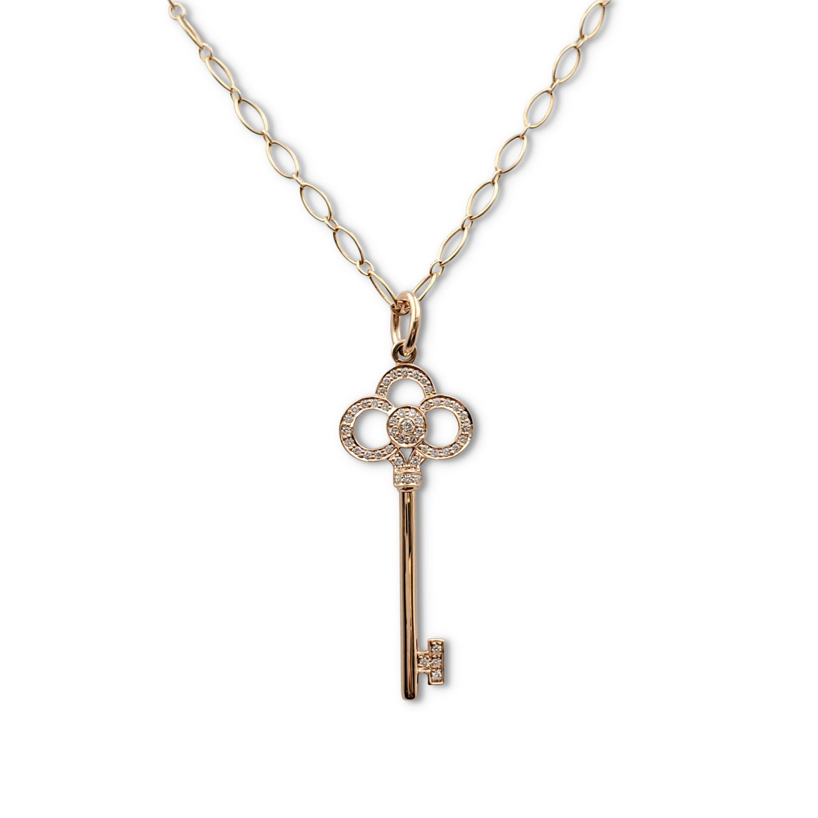 Authentic Tiffany & Co. 'Crown Key' pendant crafted in 18 karat rose gold and set with an estimated 0.13 carats of round brilliant cut diamonds (E-F, VS). The pendant hangs from a Tiffany & Co. oval-link chain necklace crafted in 18 karat rose gold