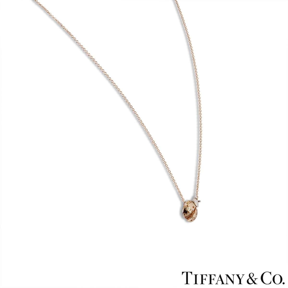 An 18k rose gold and sterling silver Ladybug pedant from the Return to Tiffany Love Bugs collection by Tiffany & Co. The pendant features a Ladybug motif with a sterling silver body and rose gold wings. The motif measures 1cm in diameter and comes